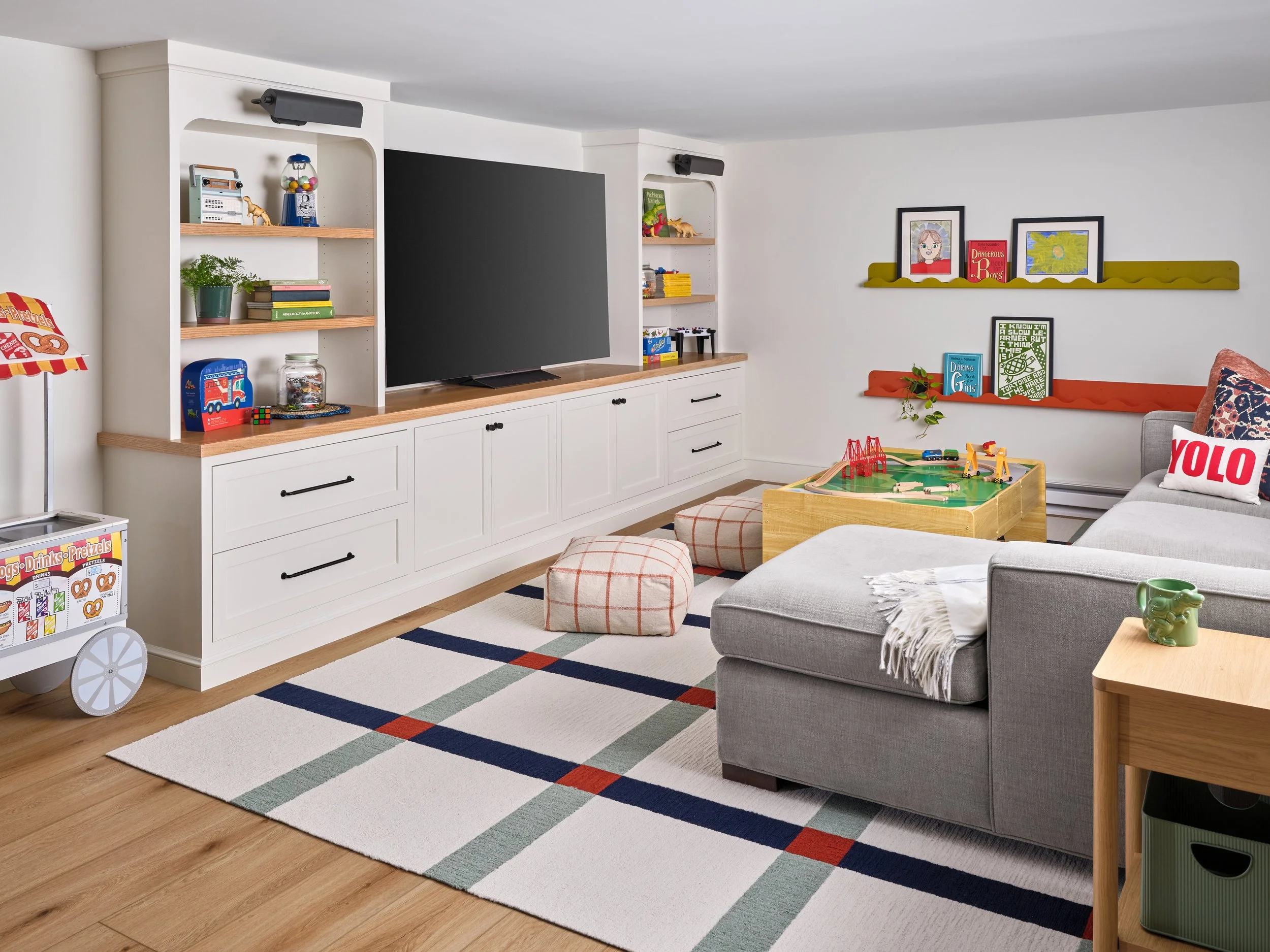 The family asked if we could repurpose their couch from their city apartment into this room which we were happy to do. The rug is comprised of separate, replaceable carpet tiles - making spots and spills easy to clean and repair.