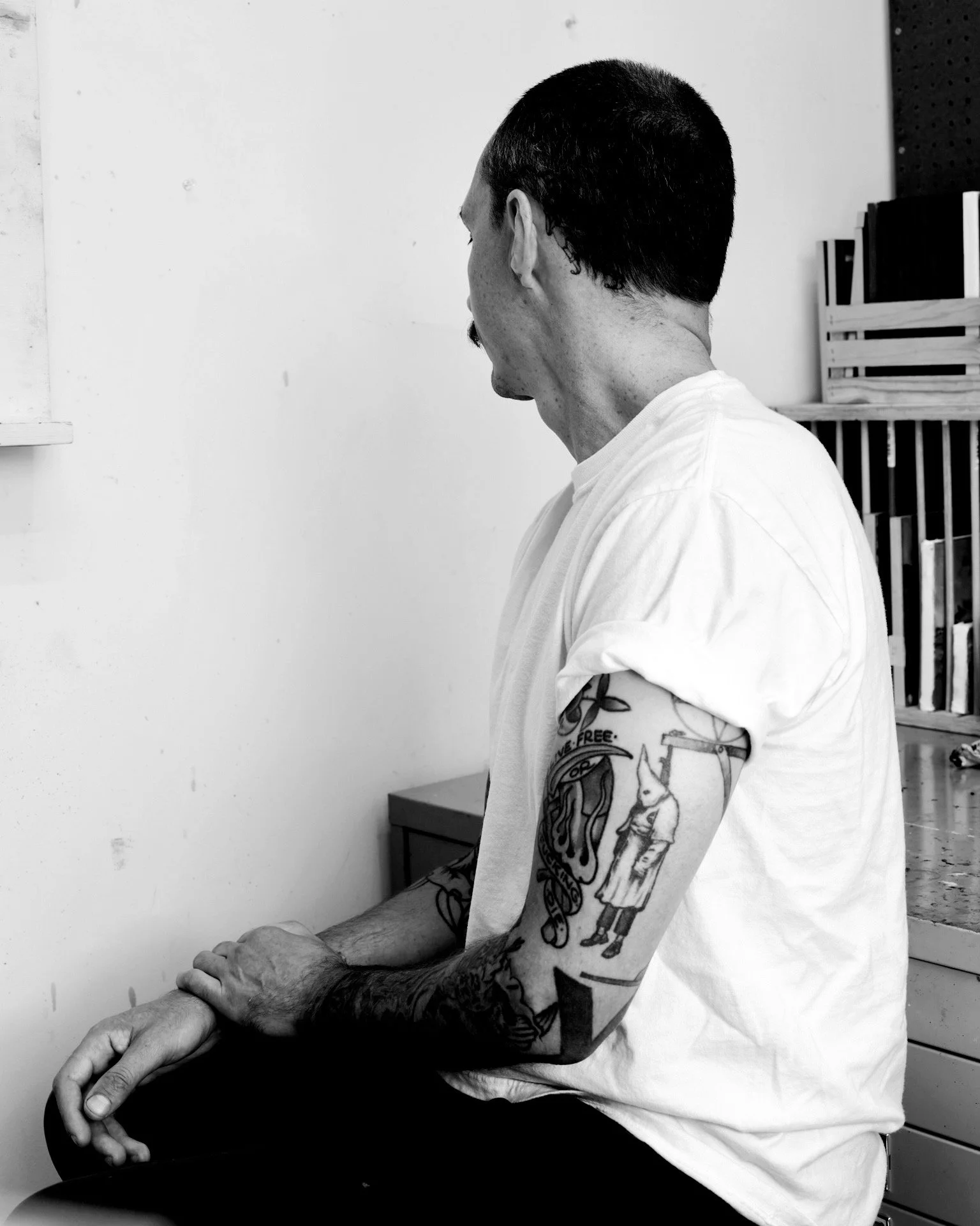 Richmond, Virginia. A KKK member hangs with a noose in a tattoo on a Richmonder's arm. 