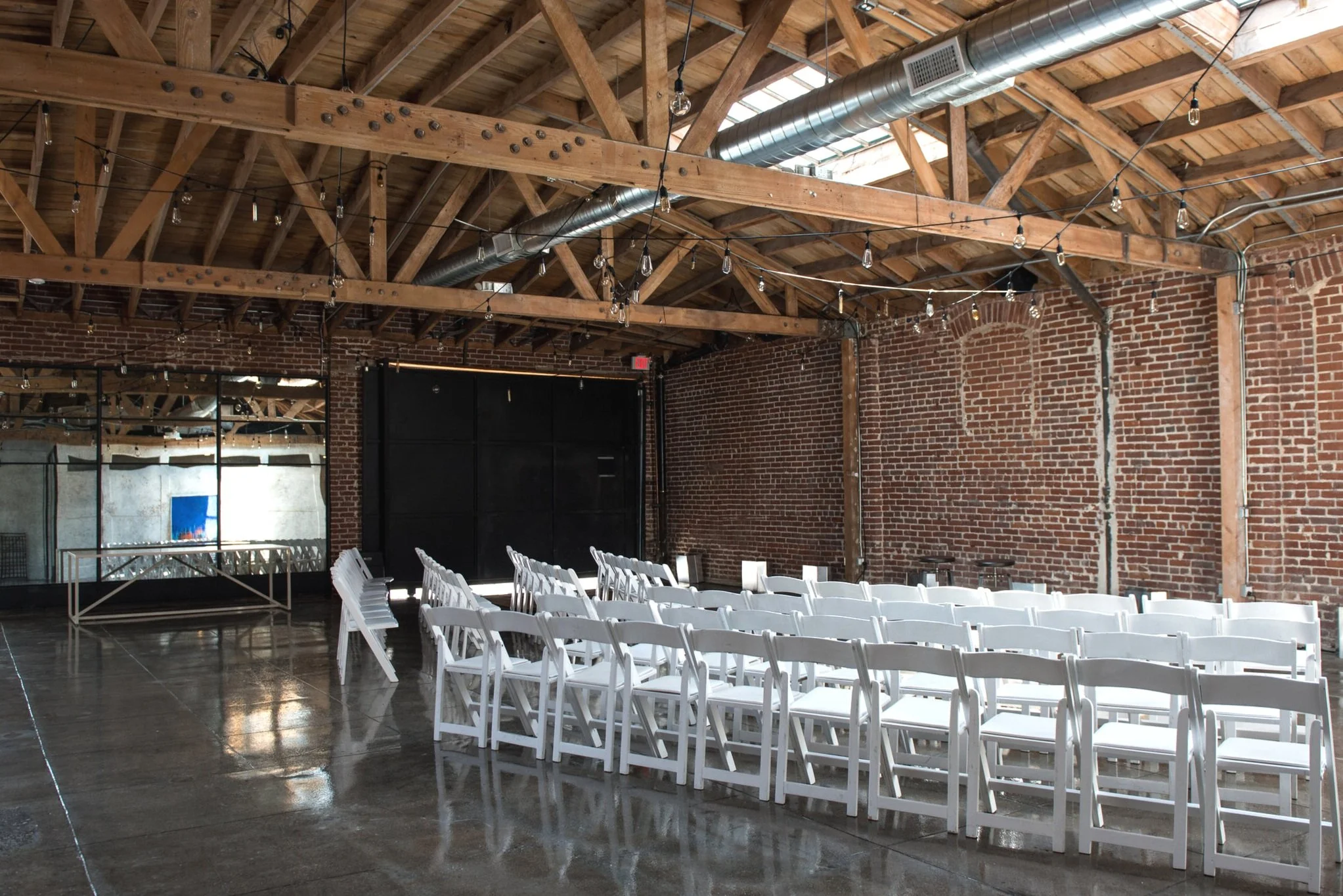  wide view of the event space set up for an event with the mirrored bar set up for cocktails 