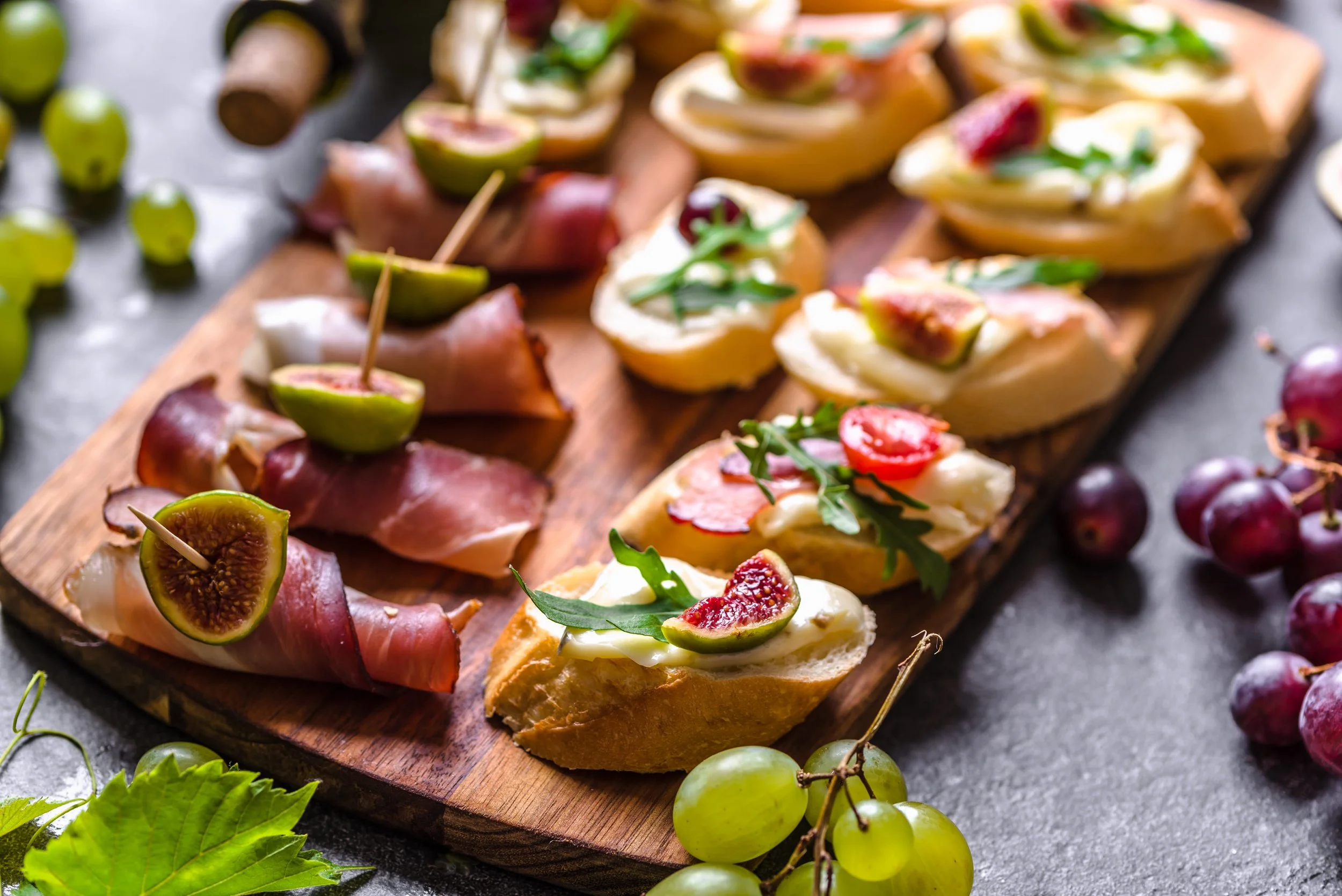 Wedding catering appetizers with fresh fruit, crostini, and charcuterie
