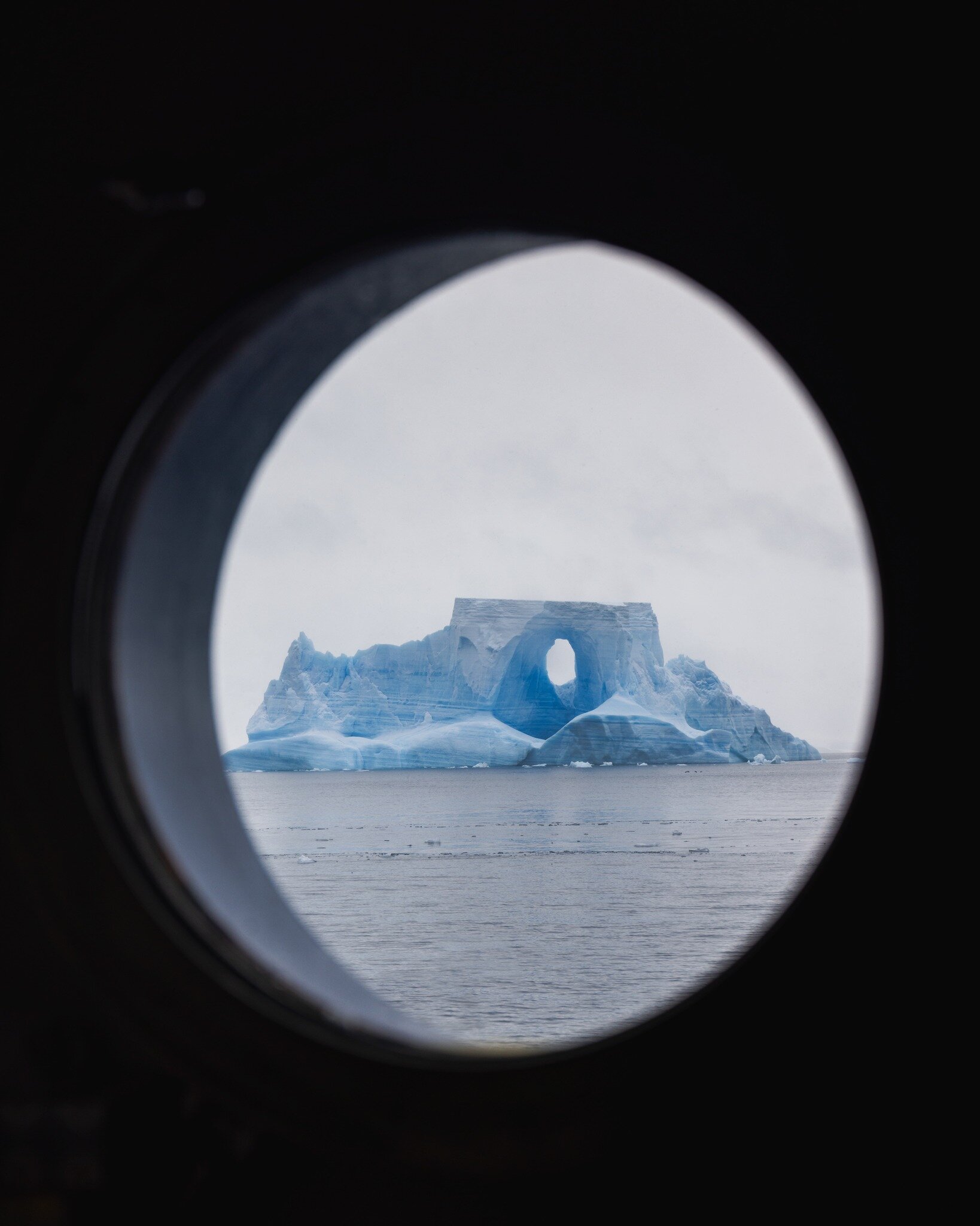 This beautiful Iceberg Arch is sitting just west of Useful Island in Antarctica. It will likely break apart soon with any amount of rough wind or weather. Even ocean swell can cause shifts in the weight and cause the ice to snap, crack, and pull apar