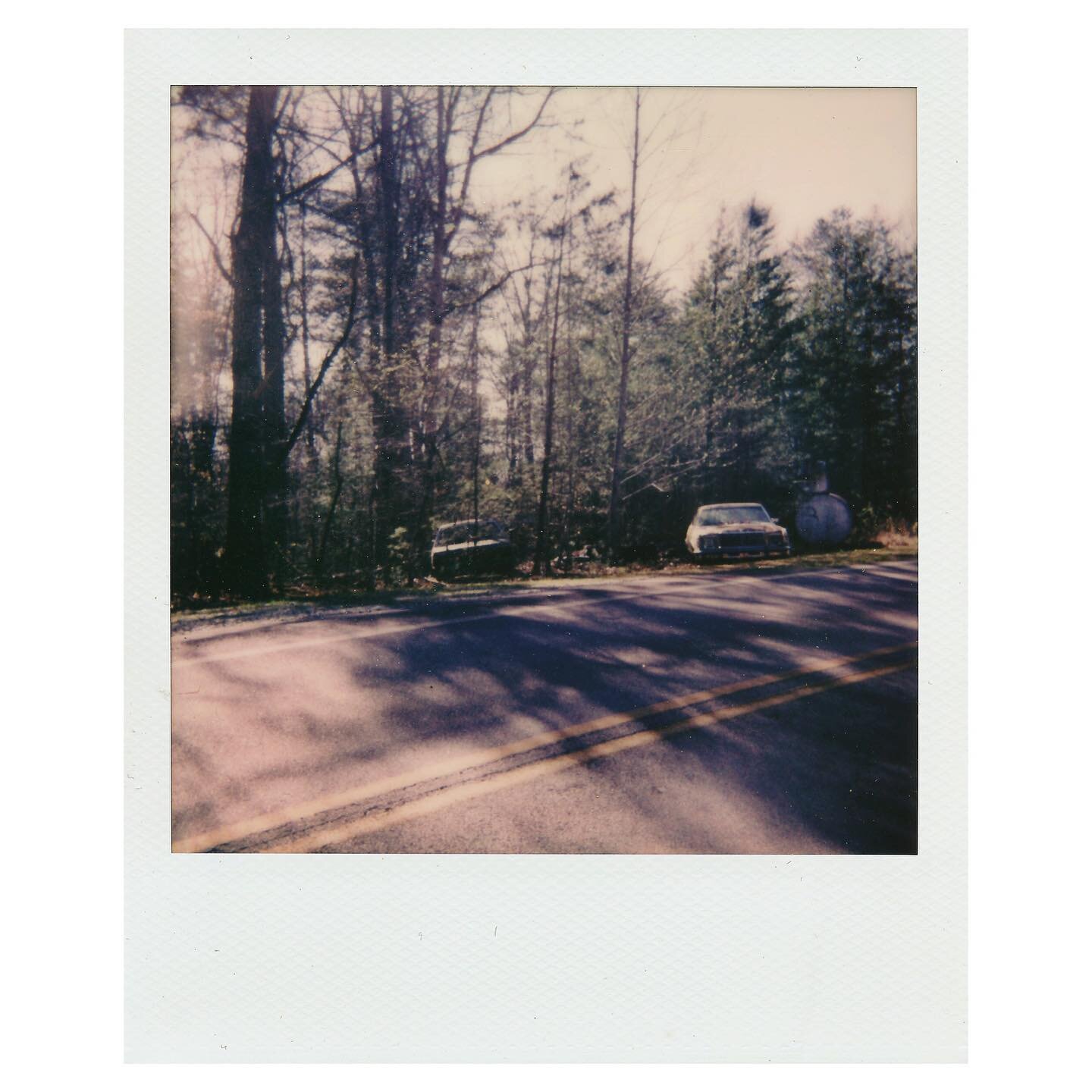 abandoned cars on the side of the road / polaroid.