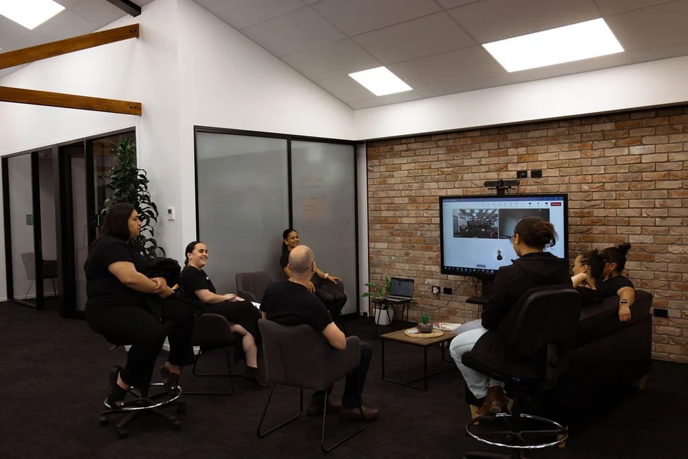 The Ake team watching a webinar in the Whakatāne office