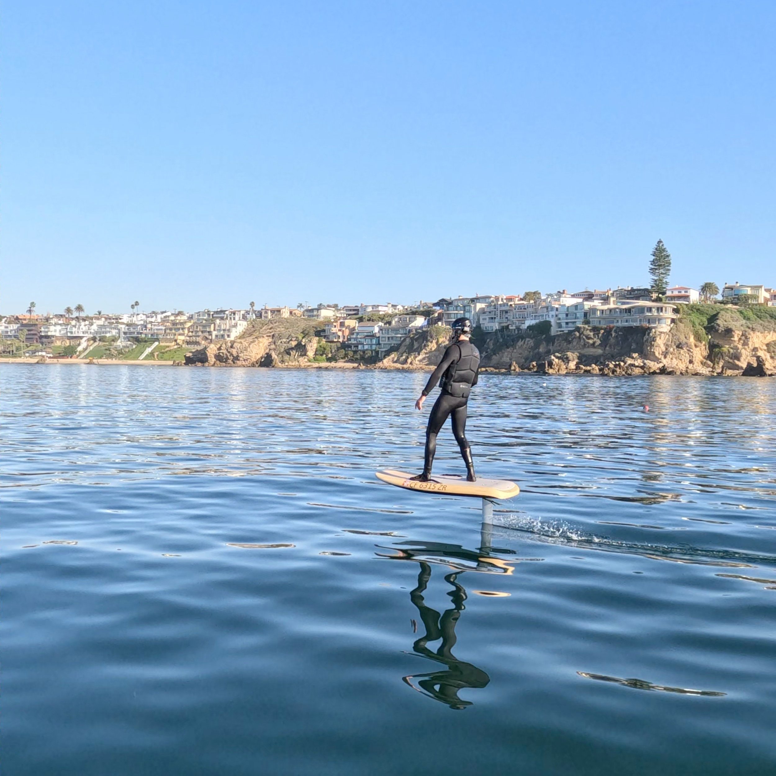 Solo rider gliding effortlessly on a Fliteboard eFoil over the water, showcasing balance, control, and the thrill of hydrofoil surfing