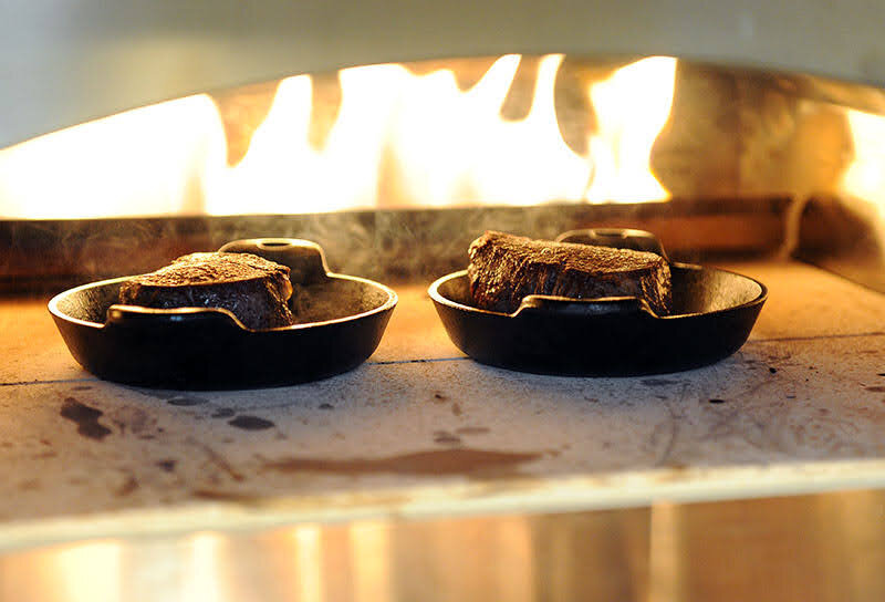 Steak searing in the Artisan Fire Pizza Oven
