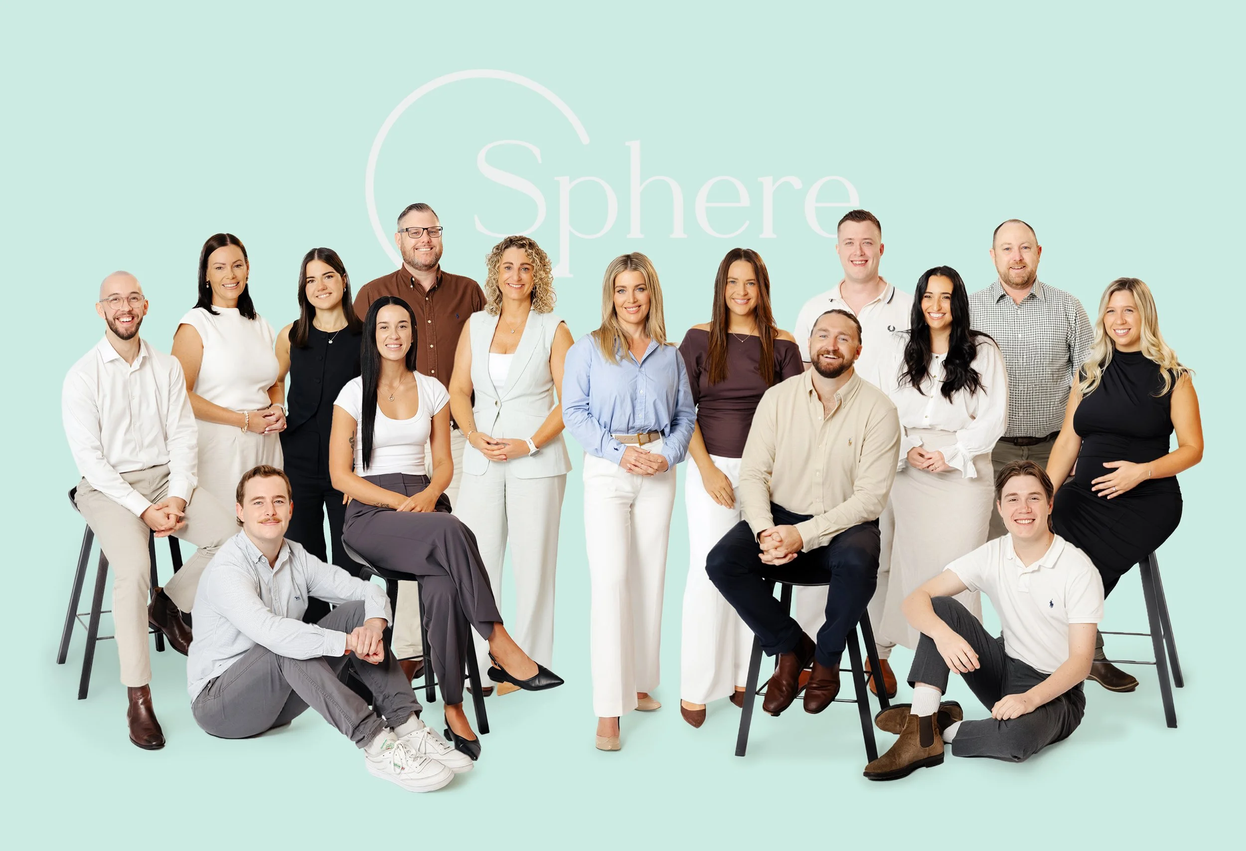 Sphere Home Loans Team of 16 people posing together against a light green background with the word 'Sphere' visible behind them.