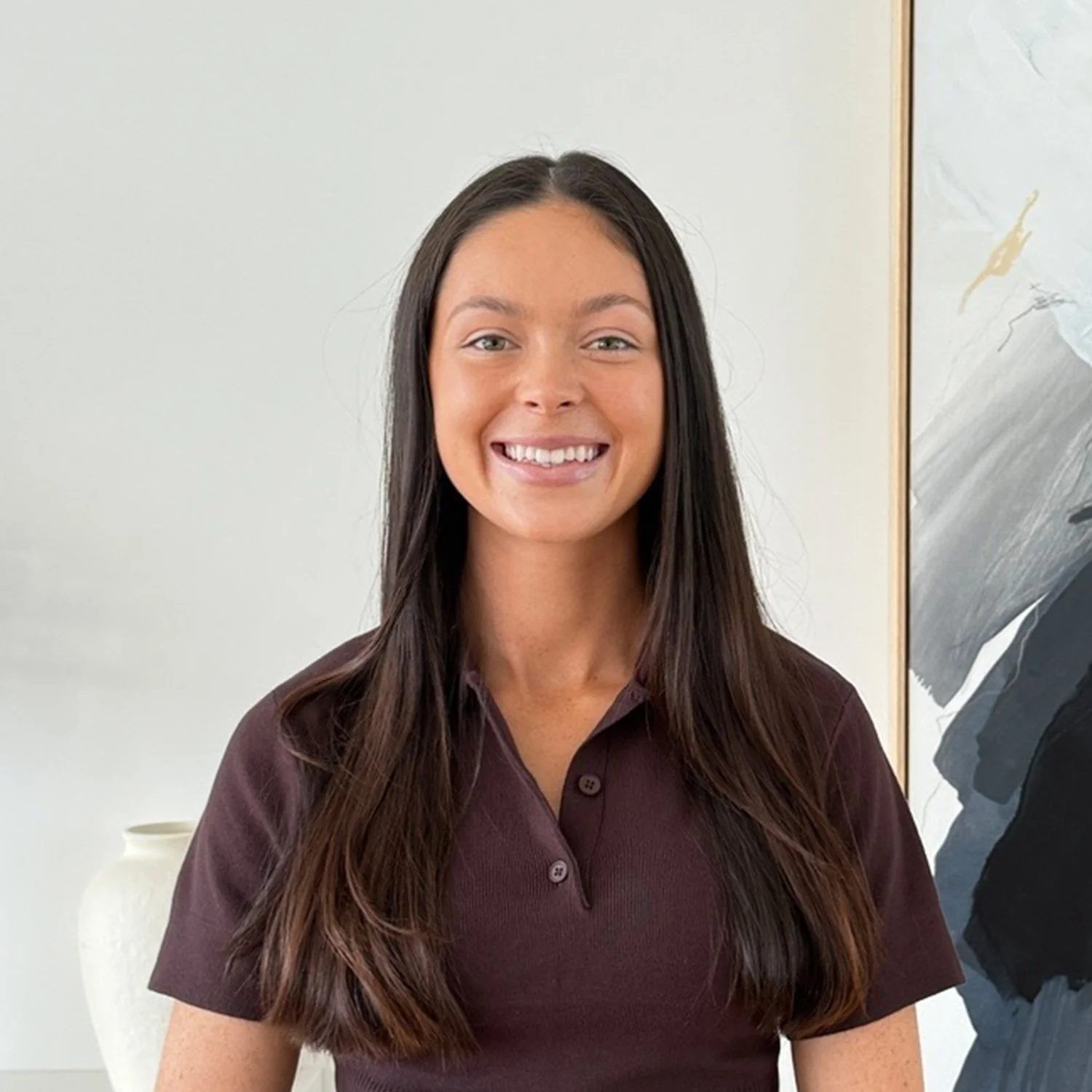 Madison Horne, Executive Assistant to Rachelle Kroon at Sphere Home Loans with long dark hair, wearing a maroon polo shirt.