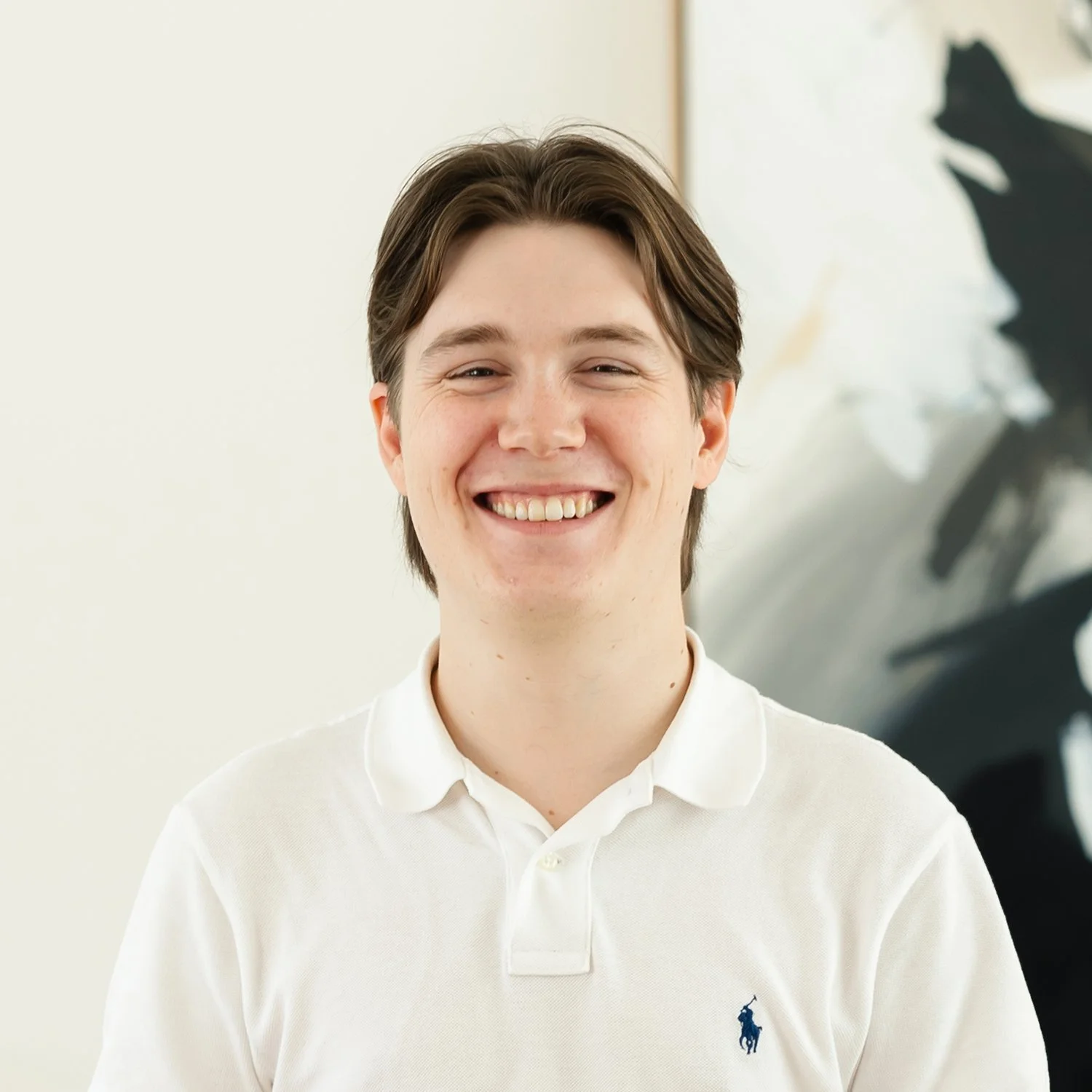 Cameron Bridge, Mortgage Broker at Sphere Home Loans with brown hair smiling, wearing a white polo shirt.