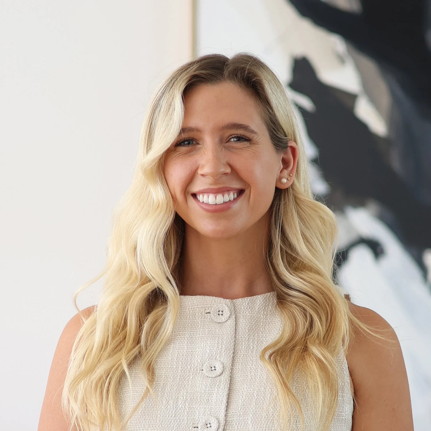 Brielle Thomas, Credit Analyst at Sphere Home Loans with long blonde hair wearing a cream-colored sleeveless top.