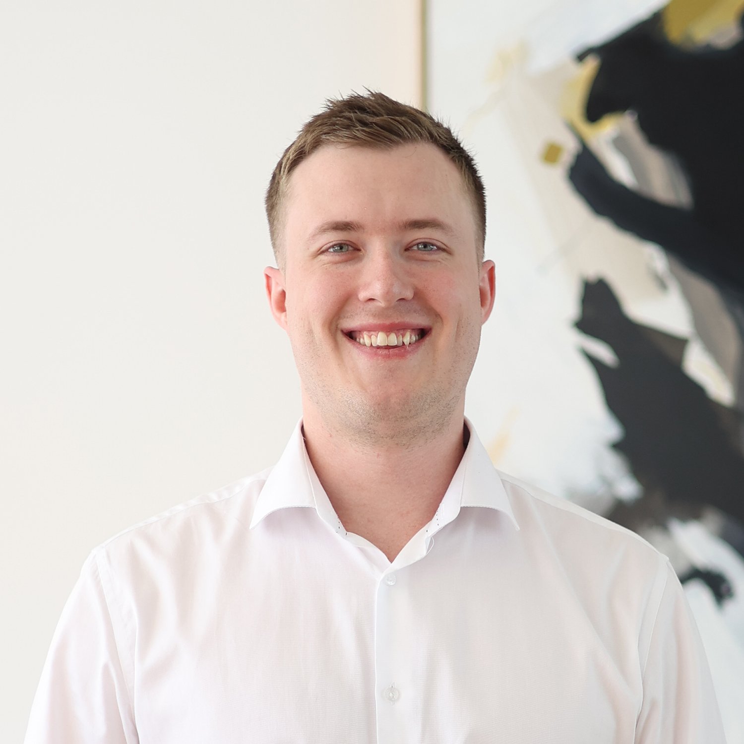 James Barron, Credit Analyst at Sphere Home Loans with short brown hair, wearing a white dress shirt.