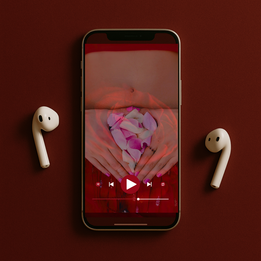 A smartphone on a red surface displaying a video thumbnail of a person forming a heart shape with flower petals using their hands. Two wireless earbuds are positioned to the left and right of the phone.