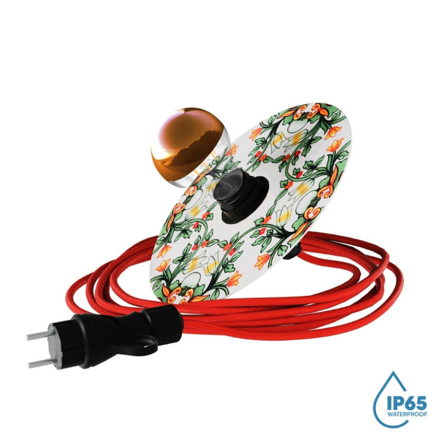 A portable outdoor lamp with a red cord, a Maioliche shade, and a gold-toned bulb.