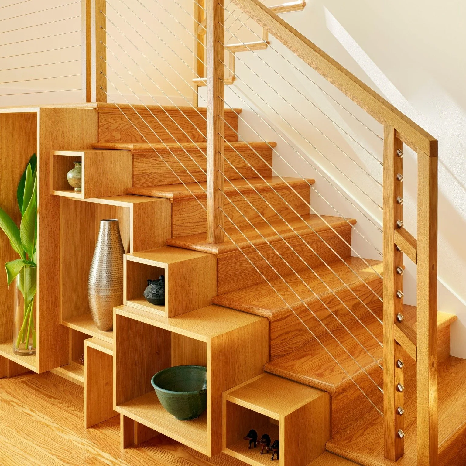 A small addition made a big difference: we opened the first floor to create a brighter, easier flow for everyday family life. Along the new stair, a custom "step-chest" turns storage into story, displaying travel finds, heirlooms, and the d