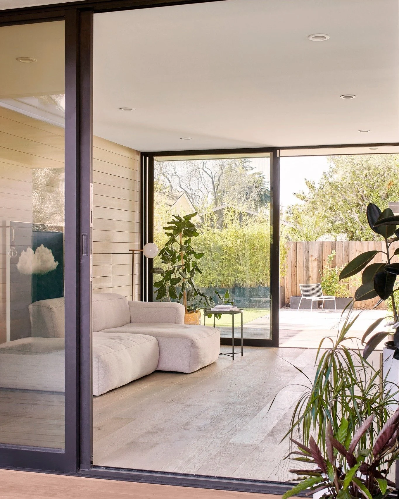In the Sub(Urban) Box, indoor/outdoor isn&rsquo;t a moment; it&rsquo;s the plan. Large sliding glass openings align from the street-facing courtyard through the living room to the rear deck, so the house reads as a single, breathable volume. When bot