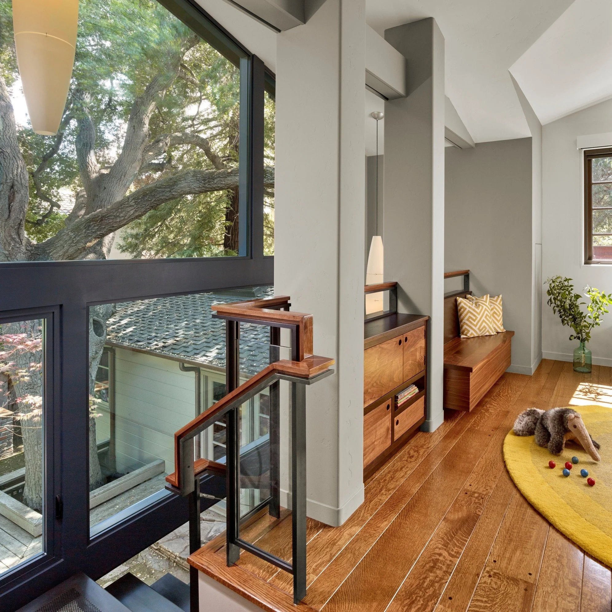 For this family&rsquo;s two young kids, heading upstairs feels like climbing into a secret tree house, perched up in the canopy of Coast Live Oaks. 🌳 The addition is anchored by a two-story glass wall and a custom stair crafted from a single folded 