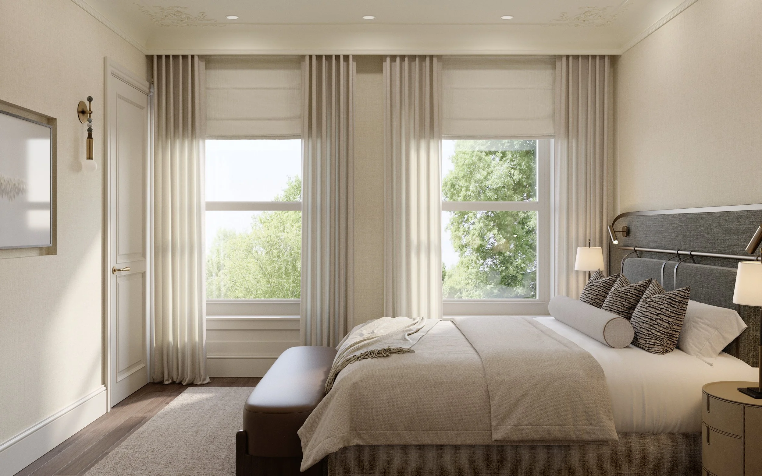 A neatly made bedroom with beige bedding, decorative pillows, two nightstands with lamps, large windows with white curtains, and a view of green trees outside.