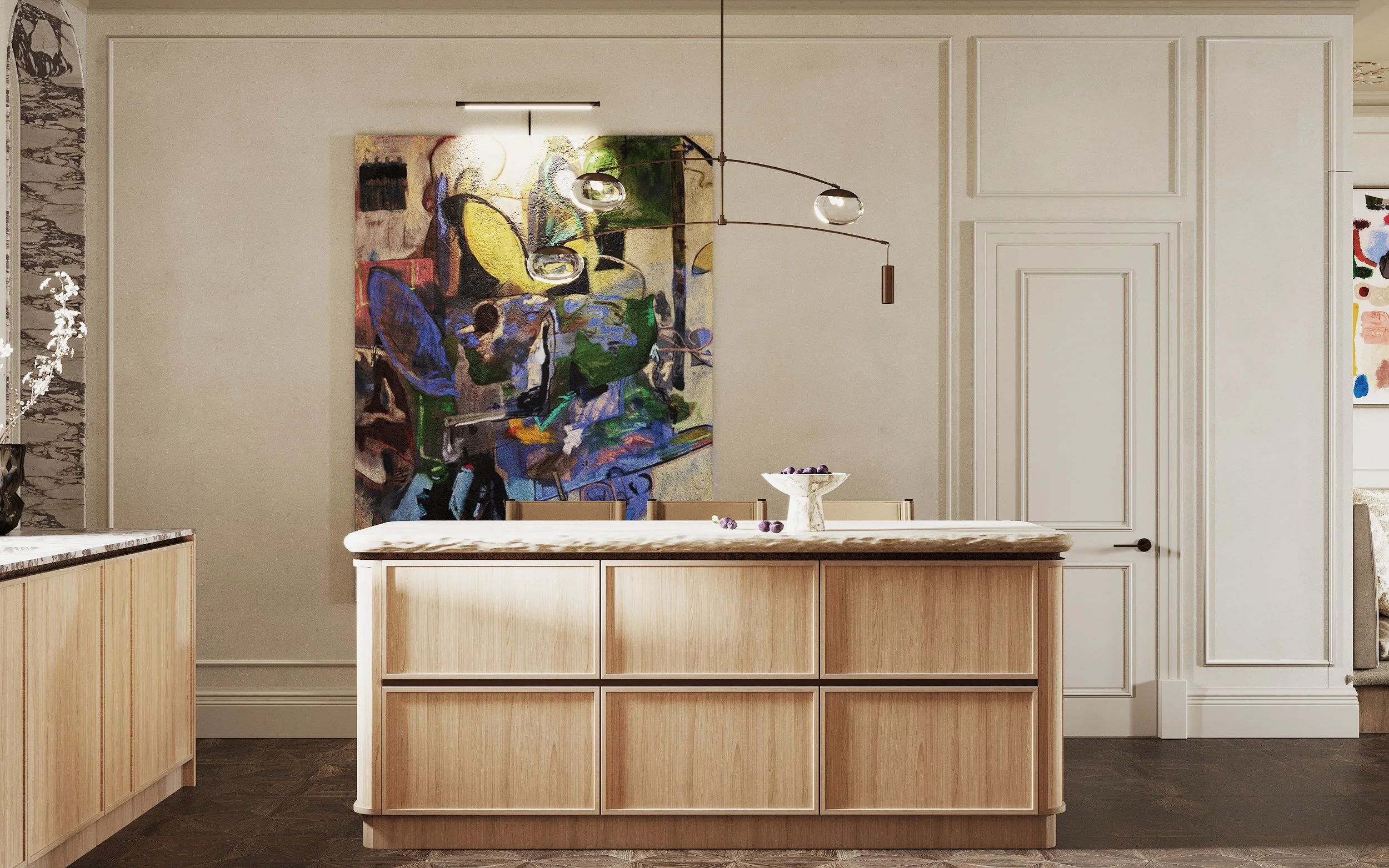 Modern kitchen with light wood island, abstract colorful painting on cream walls, and pendant lighting.