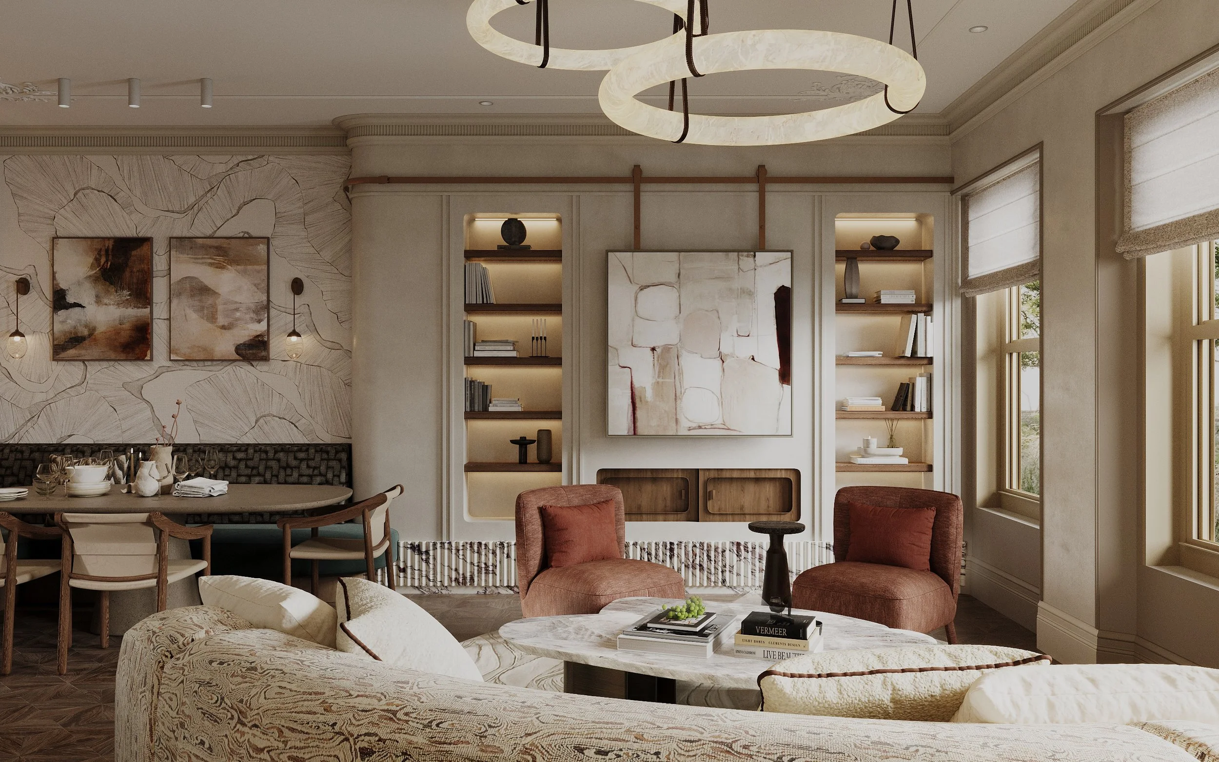 Interior of a stylish living room with beige and brown furniture, abstract art on the wall, built-in bookshelves with decorative items, and large windows with roman shades.