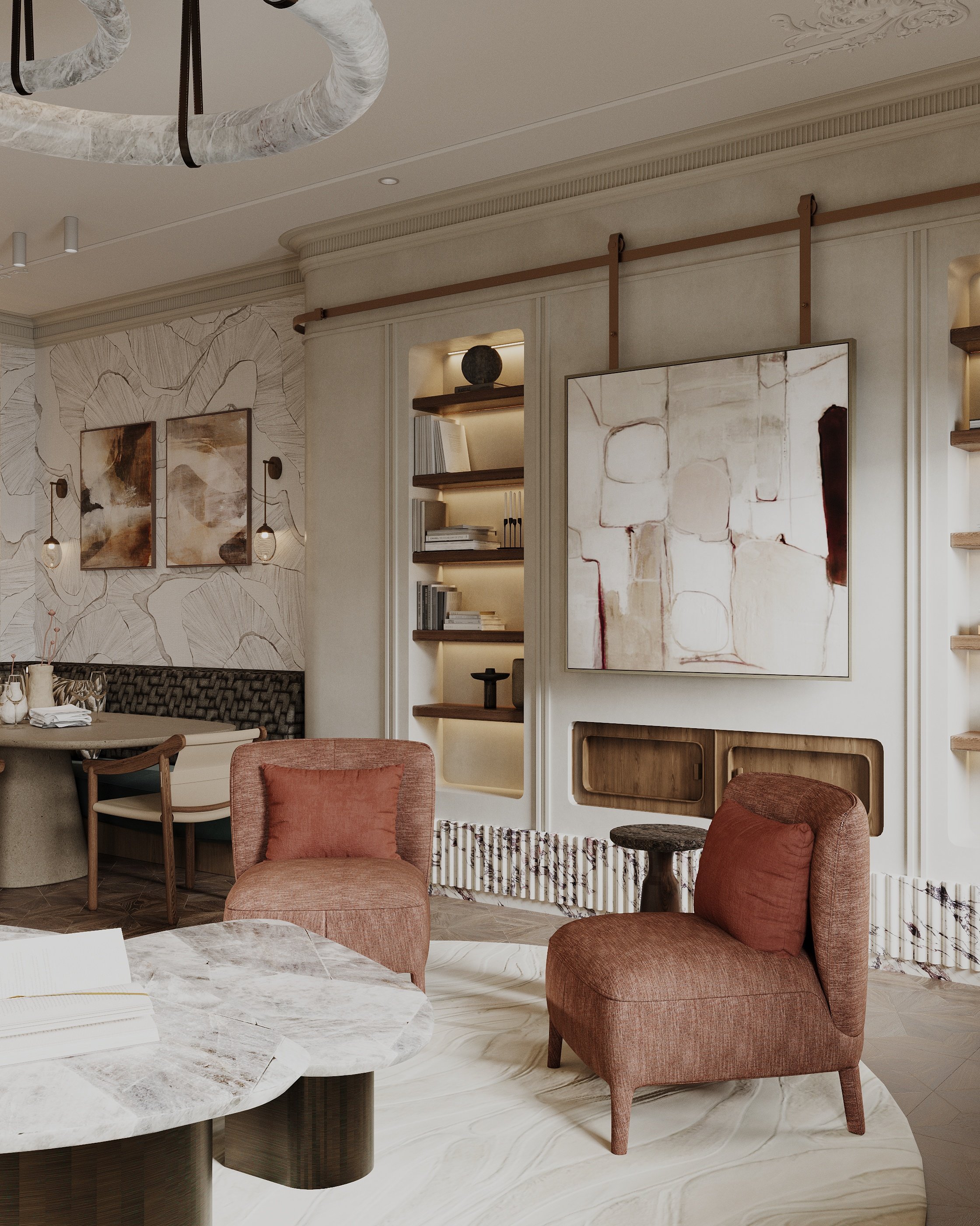 A modern living room with two pink upholstered armchairs, a marble coffee table, and built-in bookshelves with books and decorative items. Abstract artwork hangs on the wall, and a large chandelier is visible on the ceiling.