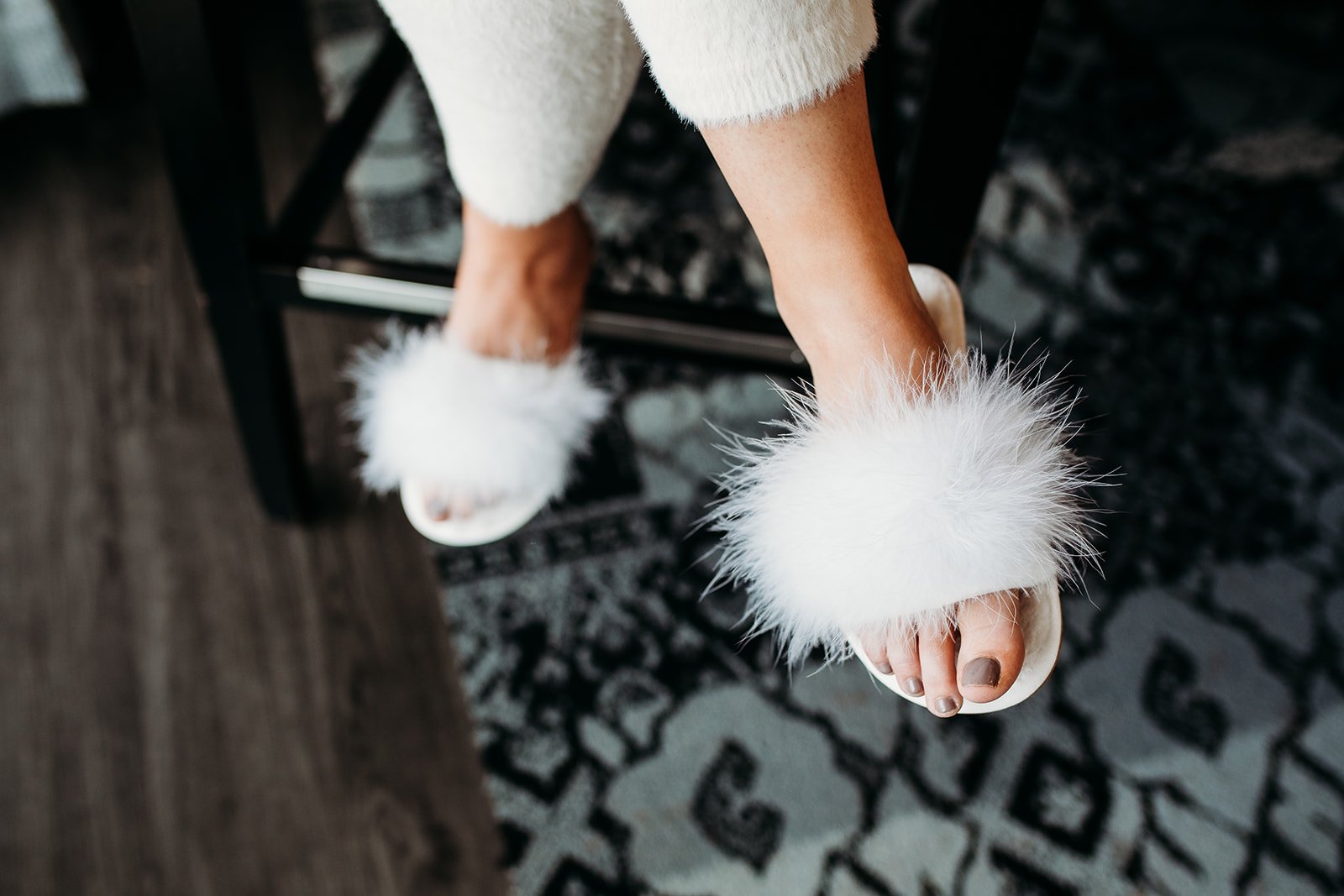 bride's fluffy slippers on her feet preparing for wedding