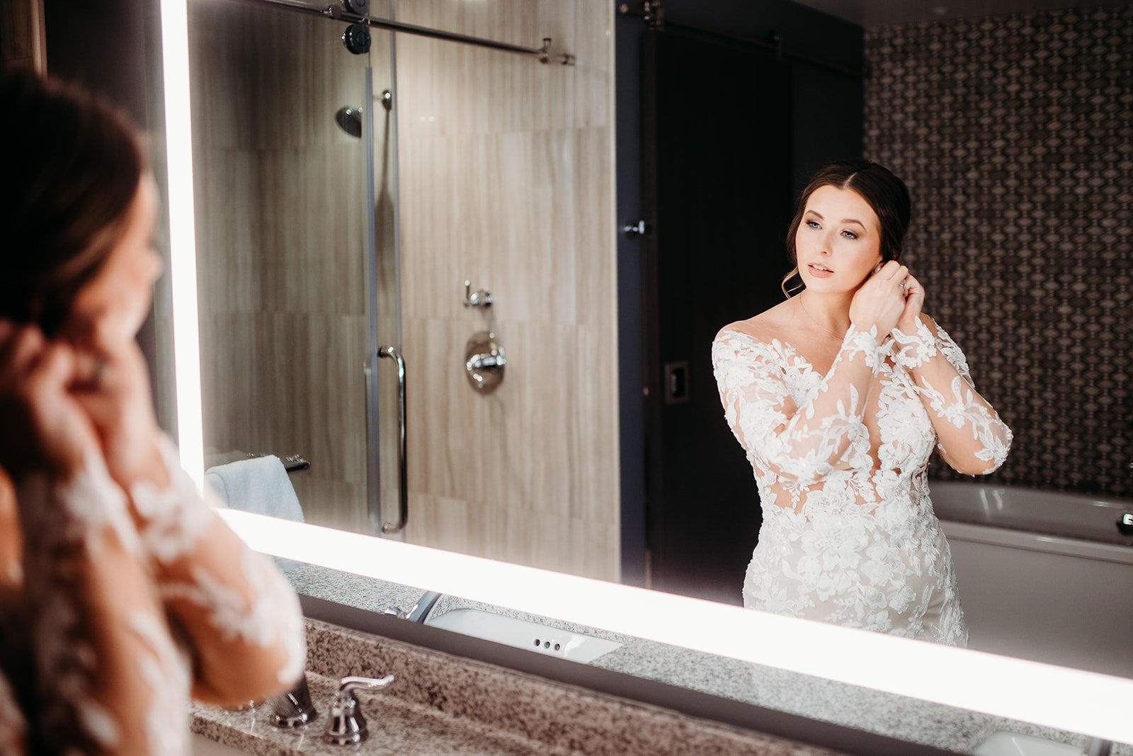 bride puts earrings on during prep for Troy NY wedding