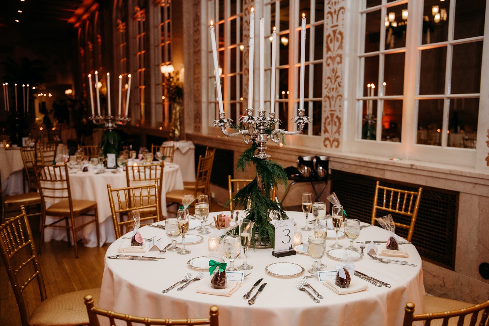 winter wedding reception with greenery and ivory details 
