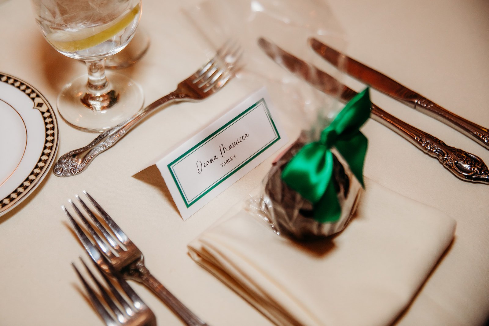 place settings with green favors for winter wedding