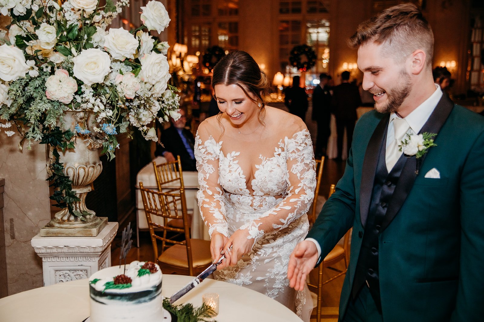 newlyweds serve wedding cake during Troy NY wedding reception