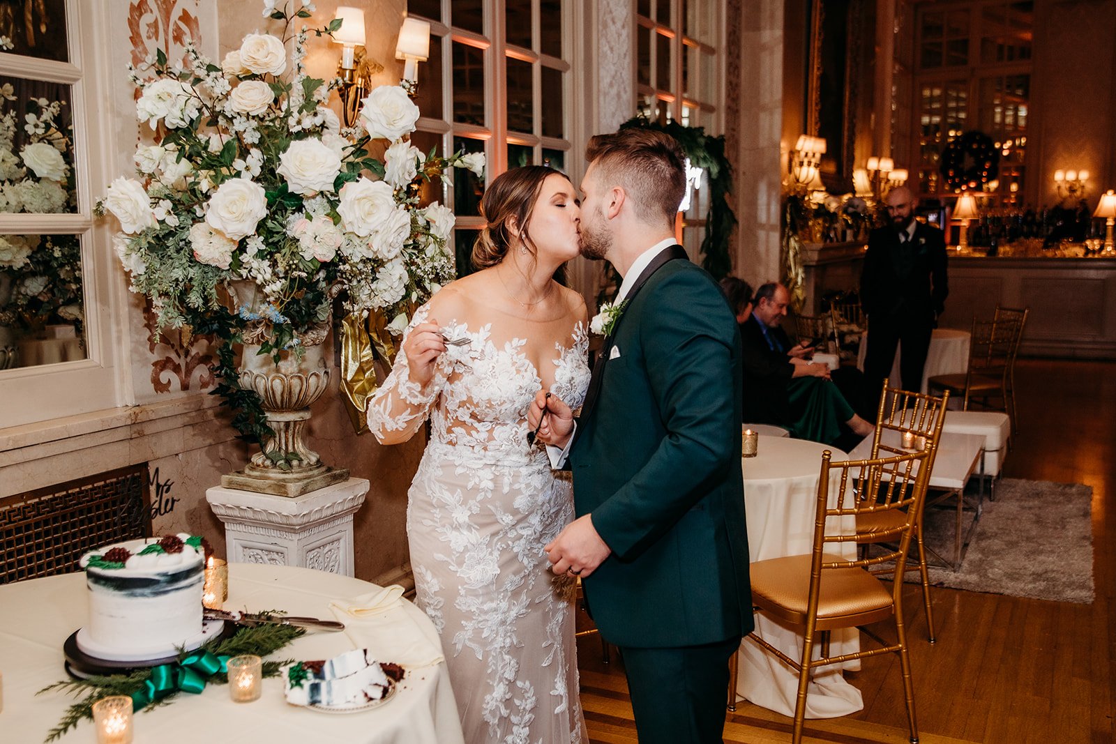 newlyweds kiss during cake cutting at Troy NY wedding reception