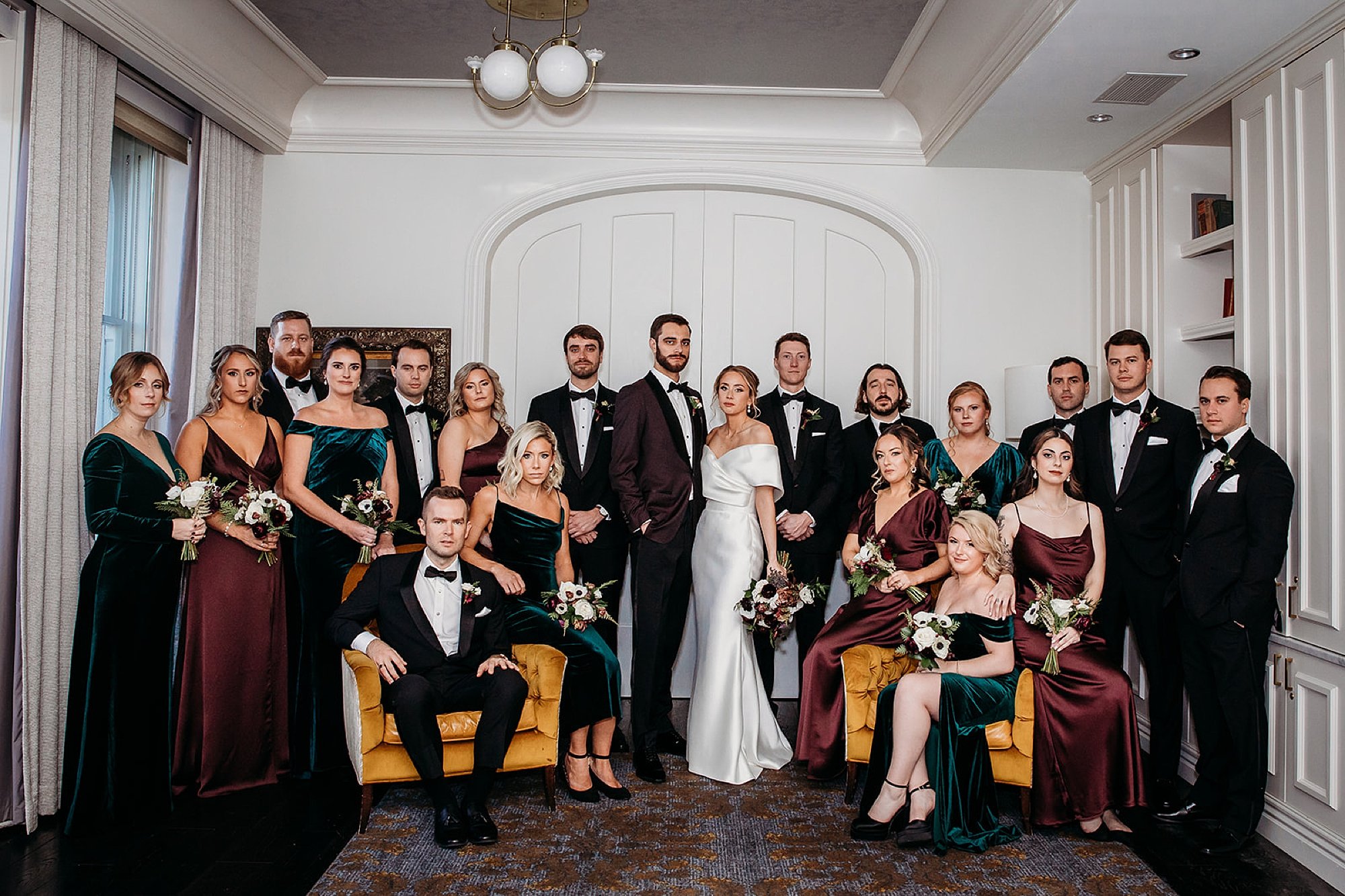 bride and groom pose with wedding party at The Adelphi Hotel