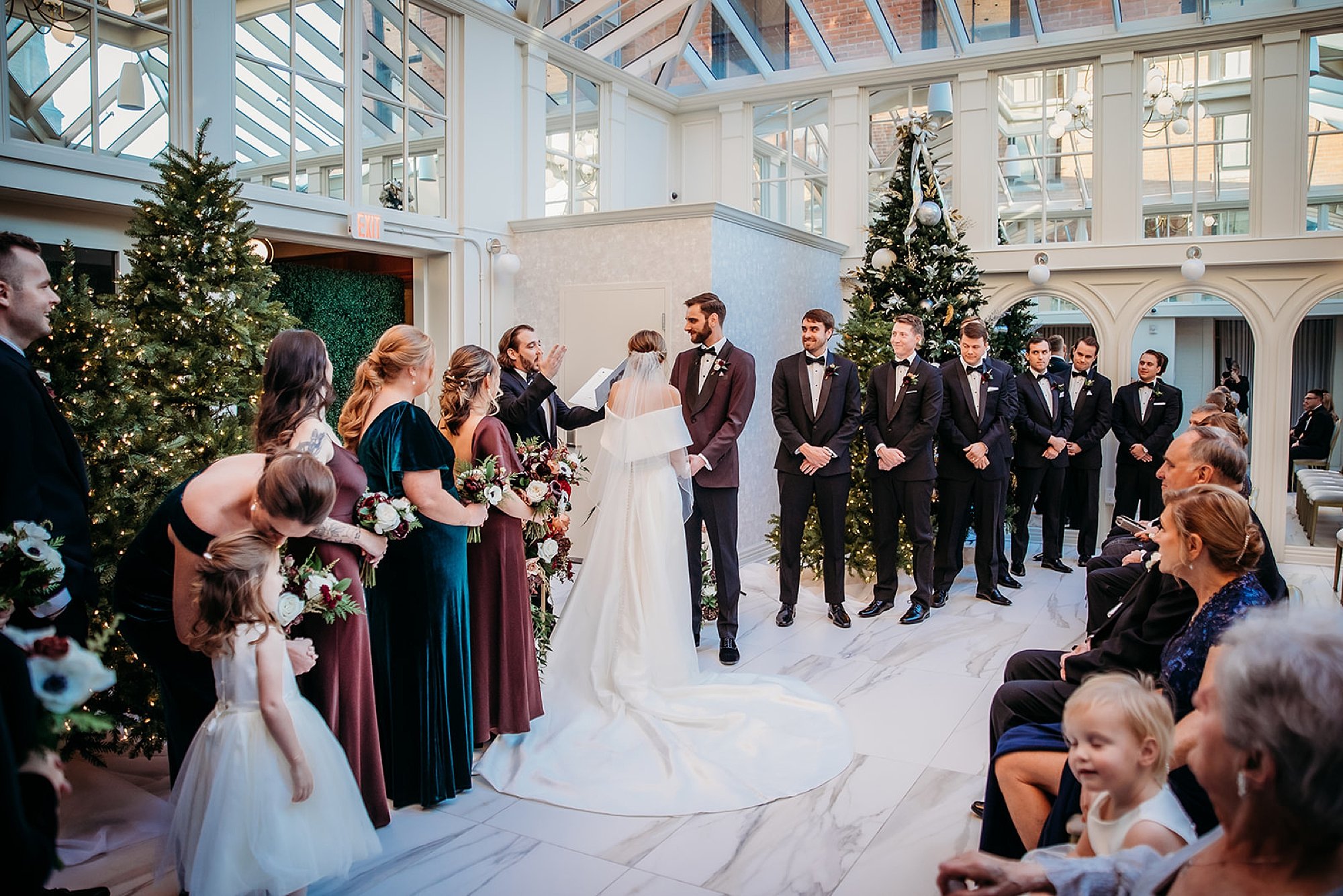 bride and groom exchange vows during wedding ceremony in atrium at The Adelphi Hotel in Saratoga Springs NY