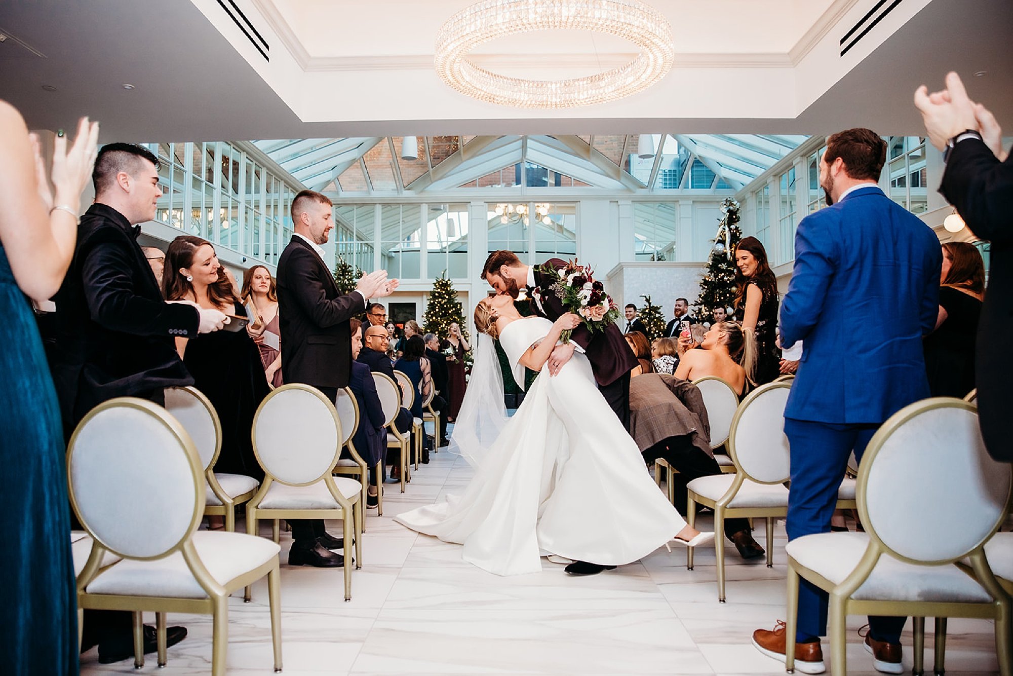 groom dips bride during wedding ceremony in atrium at The Adelphi Hotel in Saratoga Springs NY