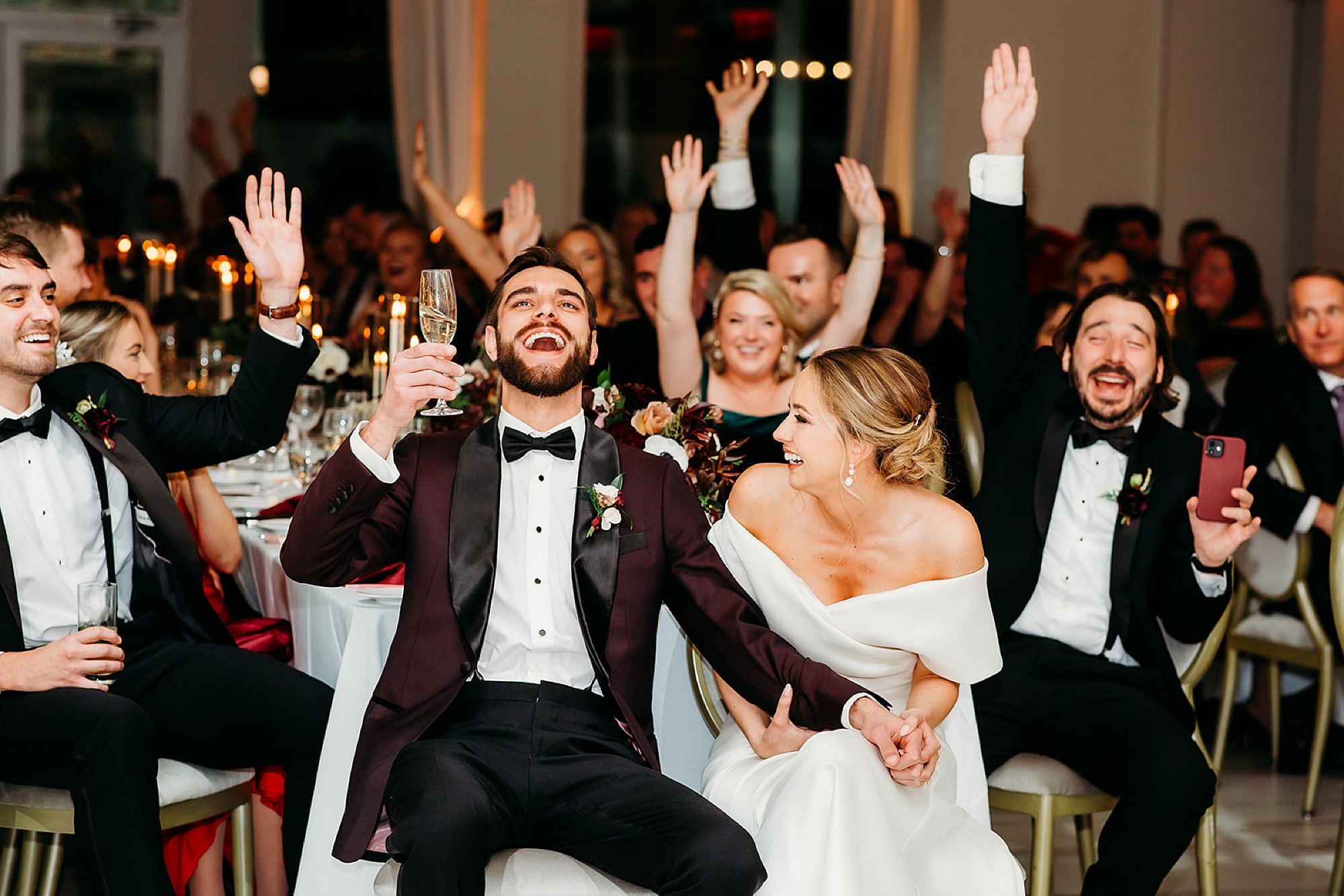 groom laughs with bride during toasts 