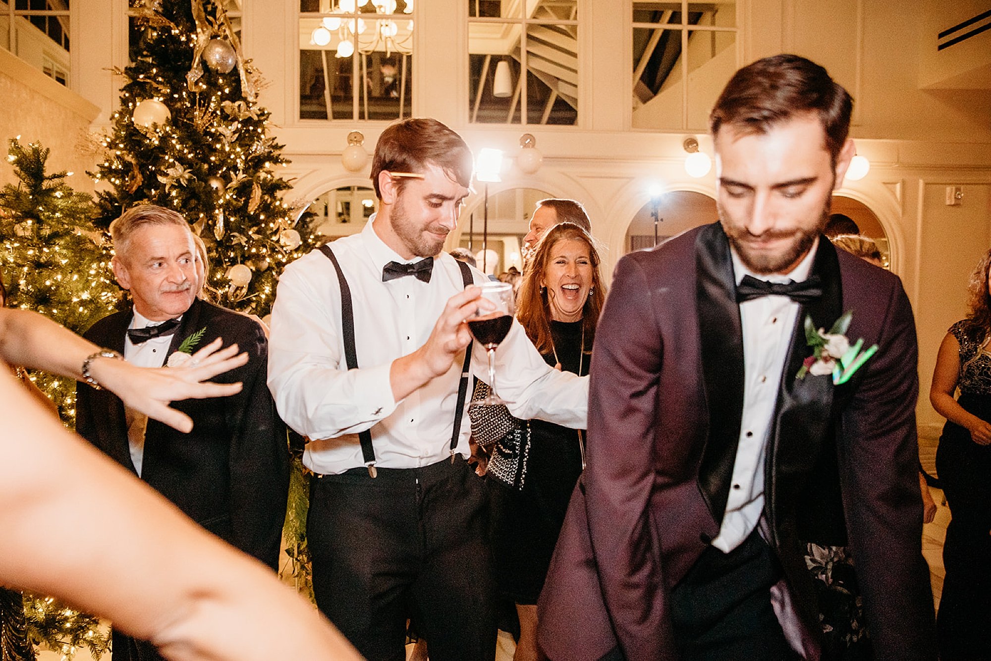 groom in burgundy suit jacket dances during reception in Saratoga Springs NY