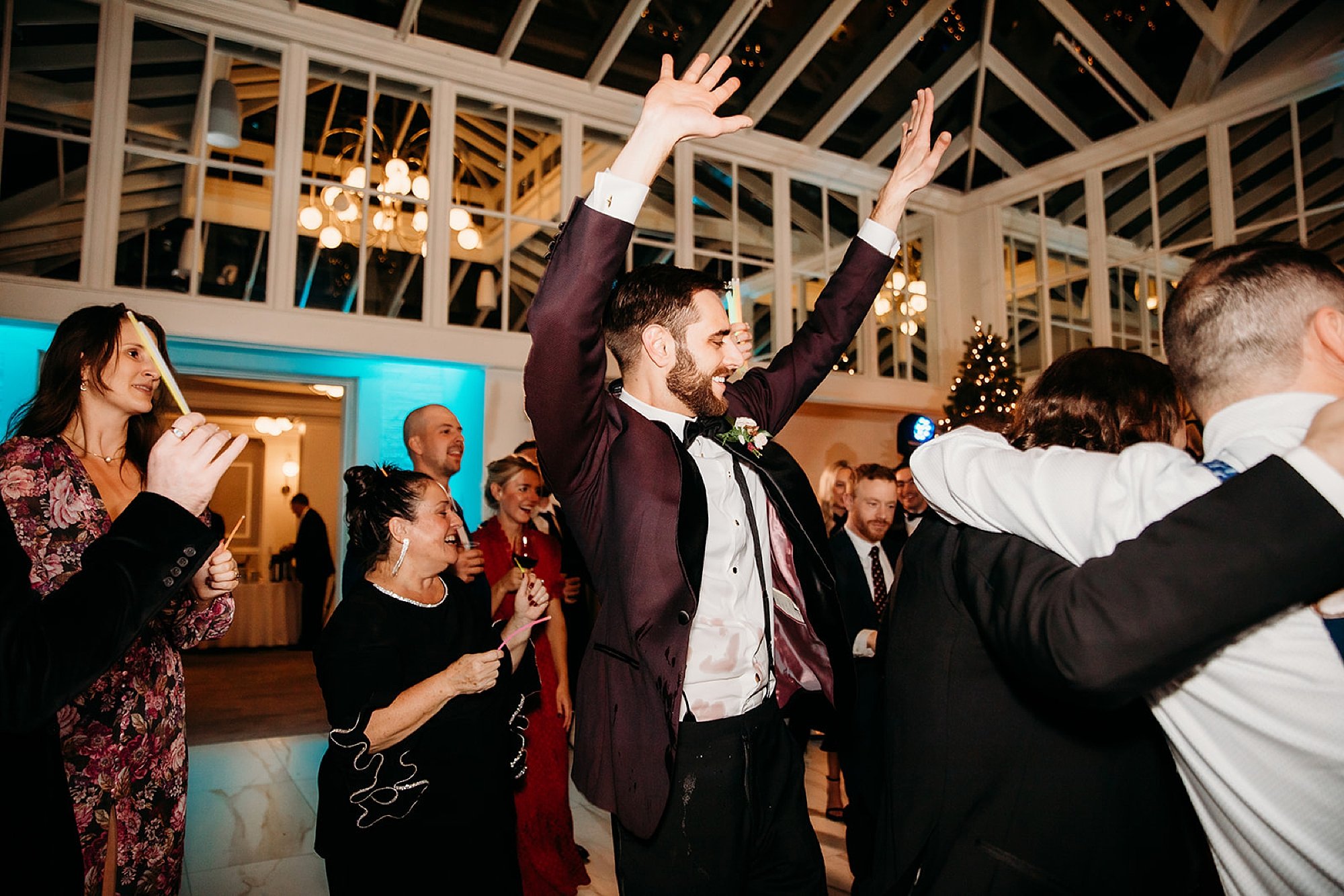 groom waves hands during reception in Saratoga Springs NY