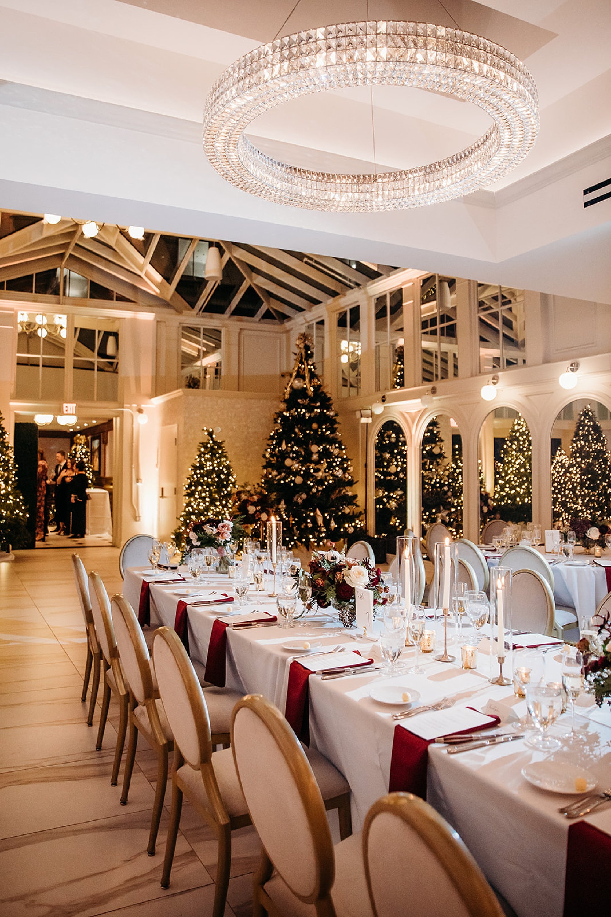 family style seating for Christmas inspired reception in the atrium at The Adelphi Hotel