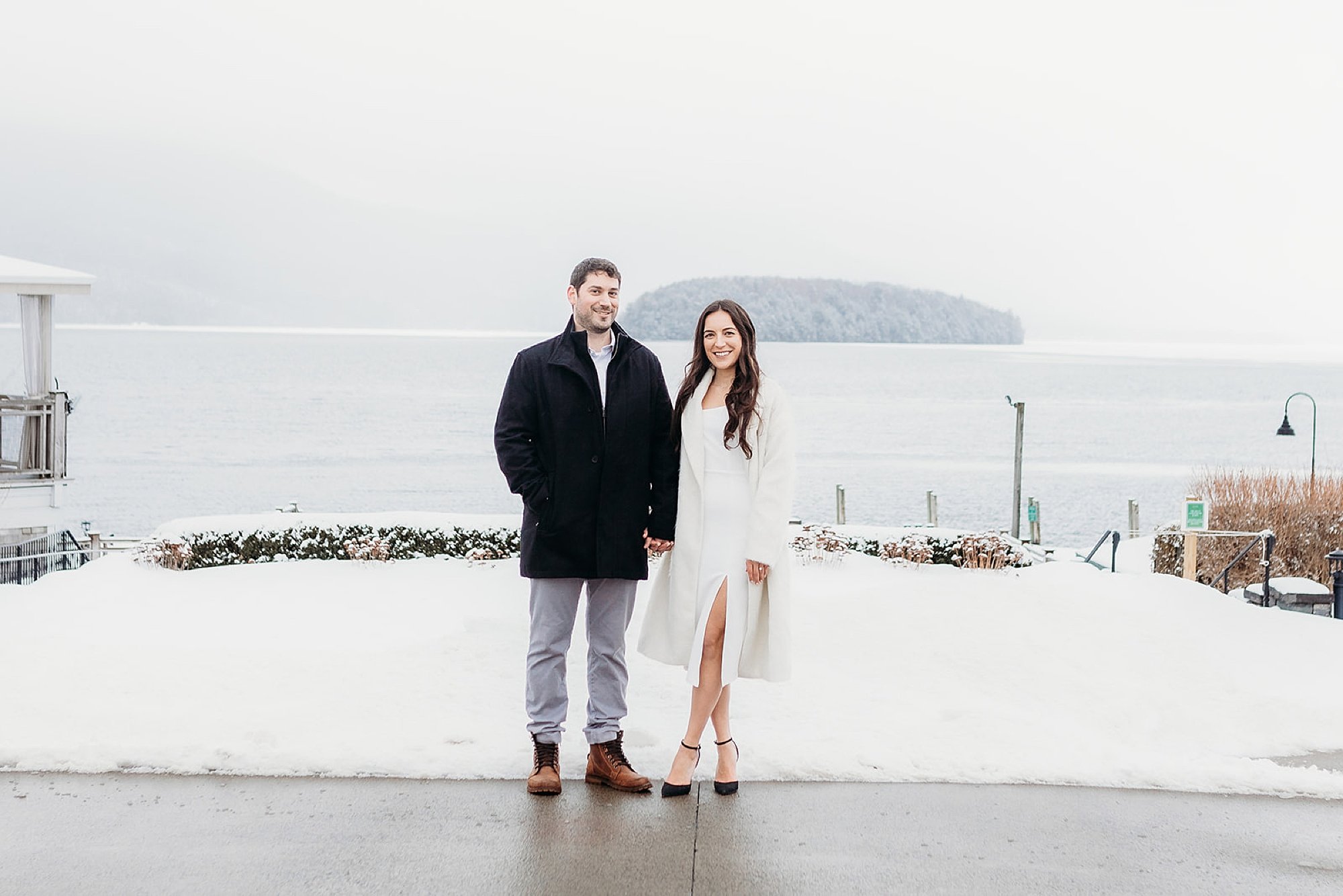 bride and groom hold hands in front of white fence at The Sagamore Resort