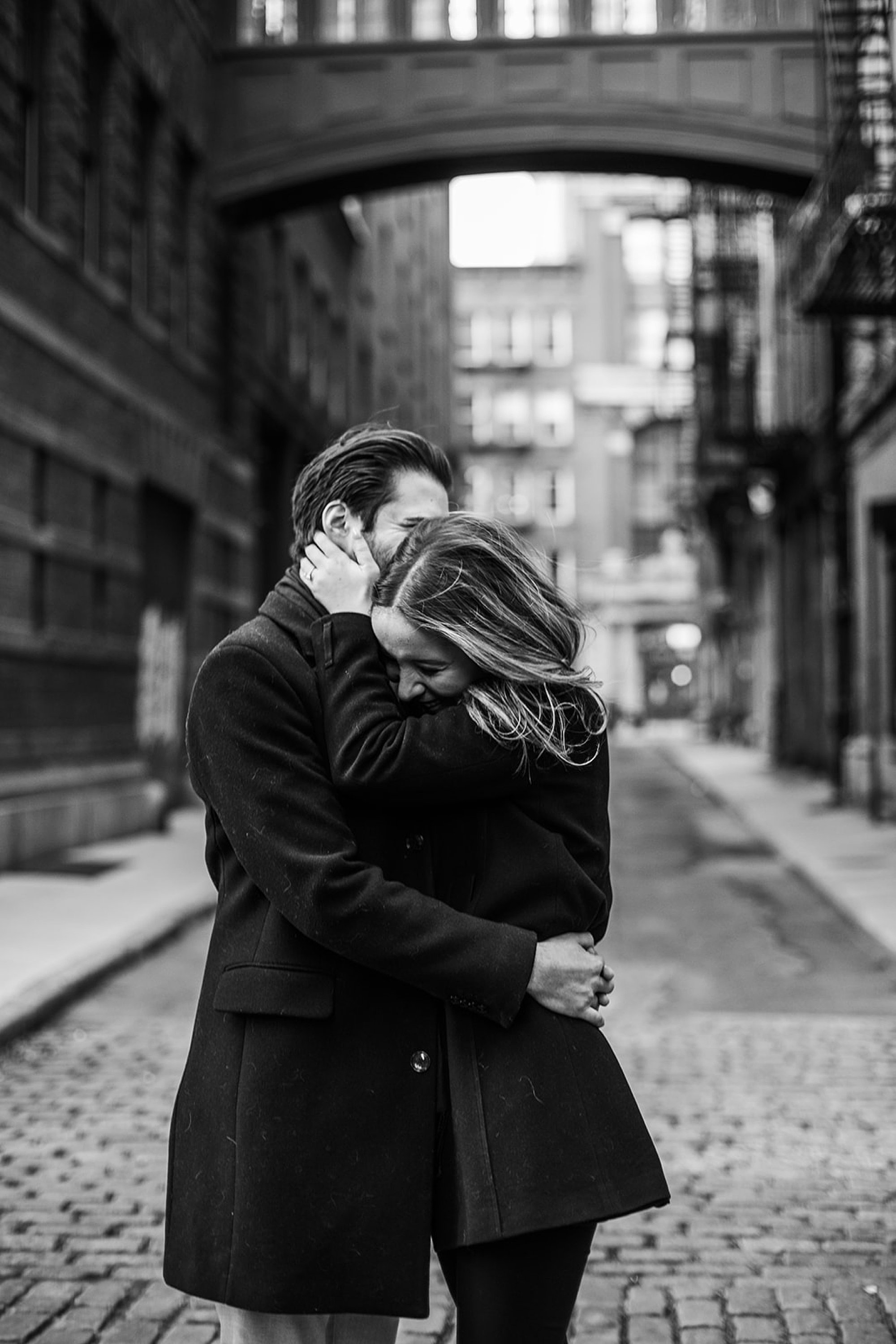 black and white portrait of man and woman hugging on streets in Tribeca NY