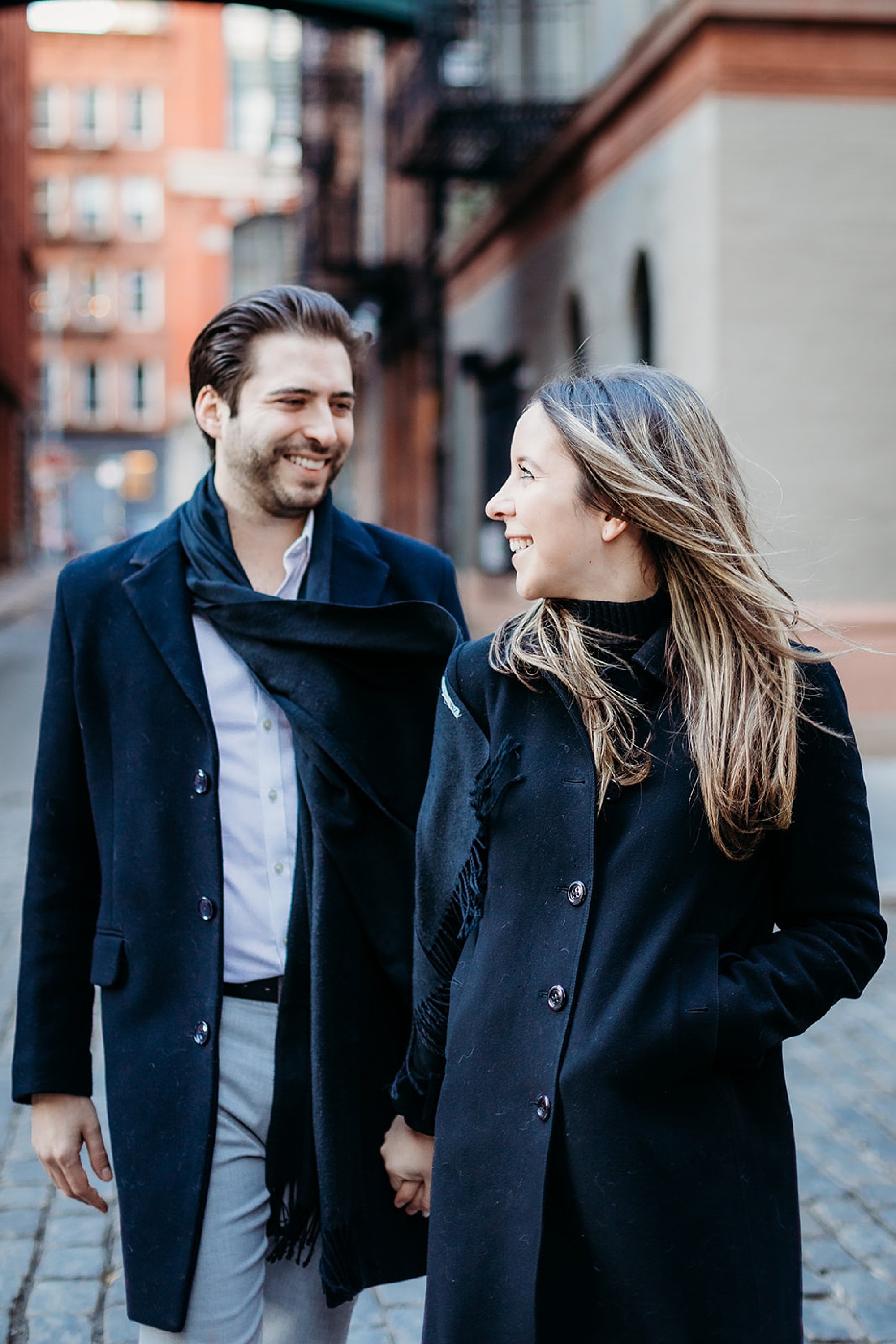 woman looks back at fiance during walk through Tribeca NY