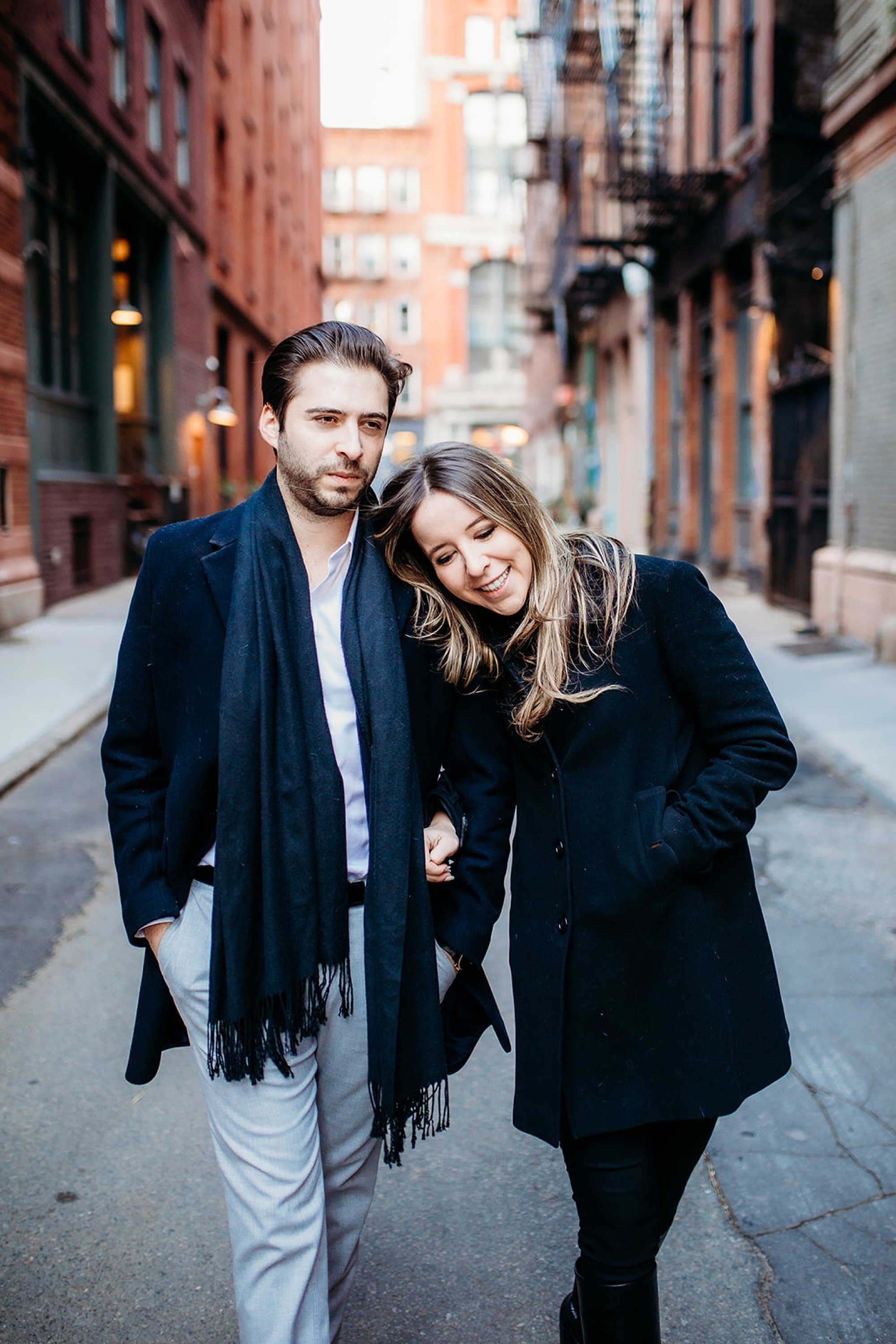 woman leans head on groom's shoulder walking through Tribeca NY