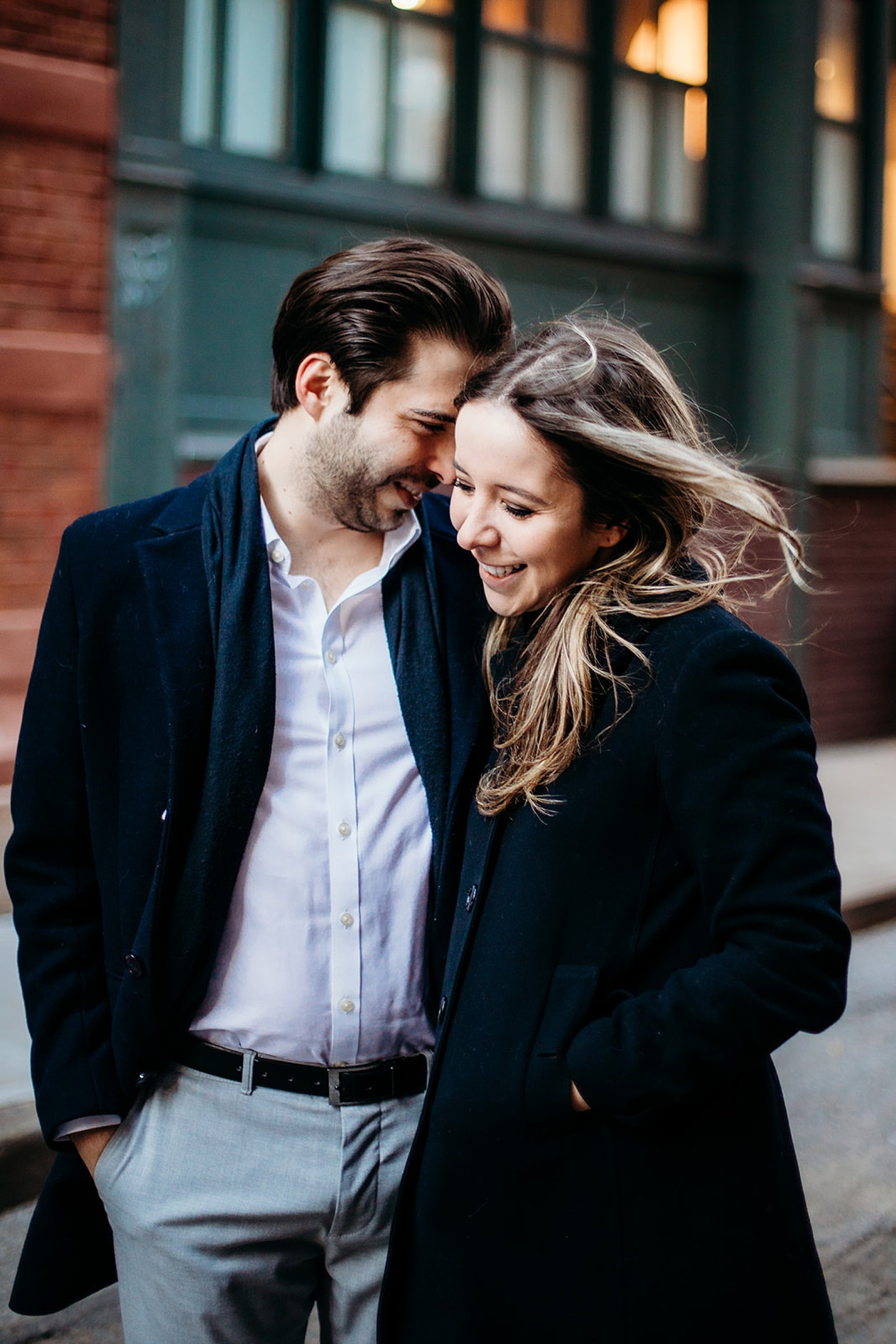 man nuzzles woman's forehead during classic NYC engagement session in Tribeca NY