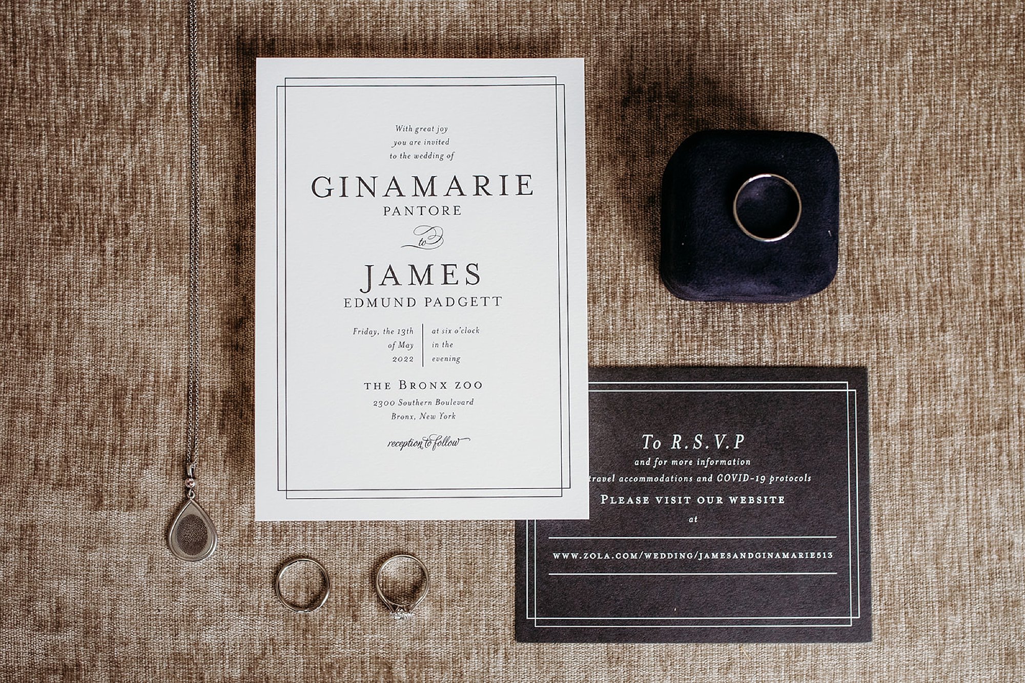 black and white invitation suite next to wedding rings for New York wedding 