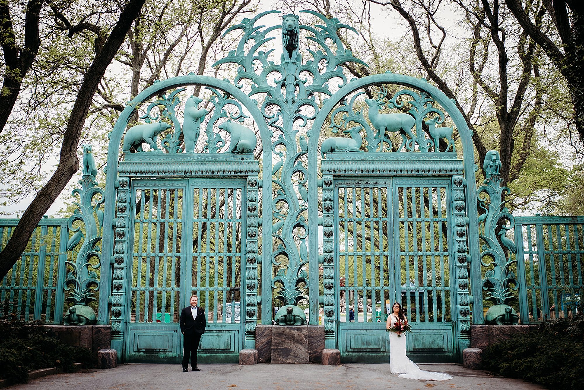 bride and groom stand on opposite ends of the Rainey Memorial Garden at the Bronx Zoo