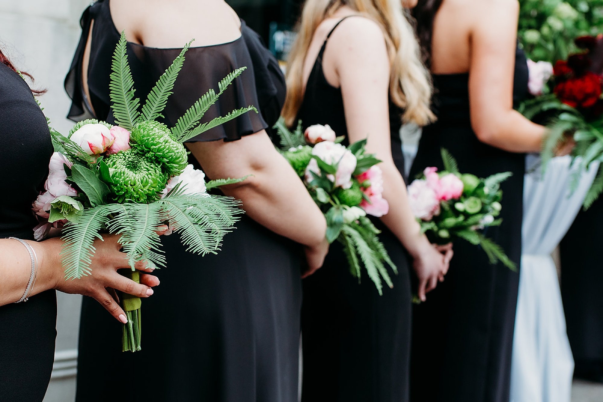 bridesmaids hold tropical bouquets 