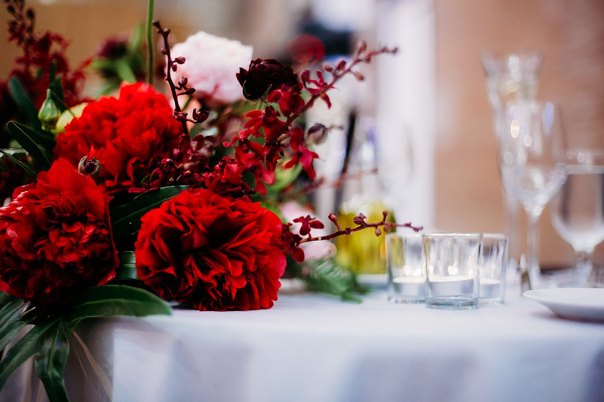 red floral accents for The Bronx Zoo wedding reception at the Old Lion House
