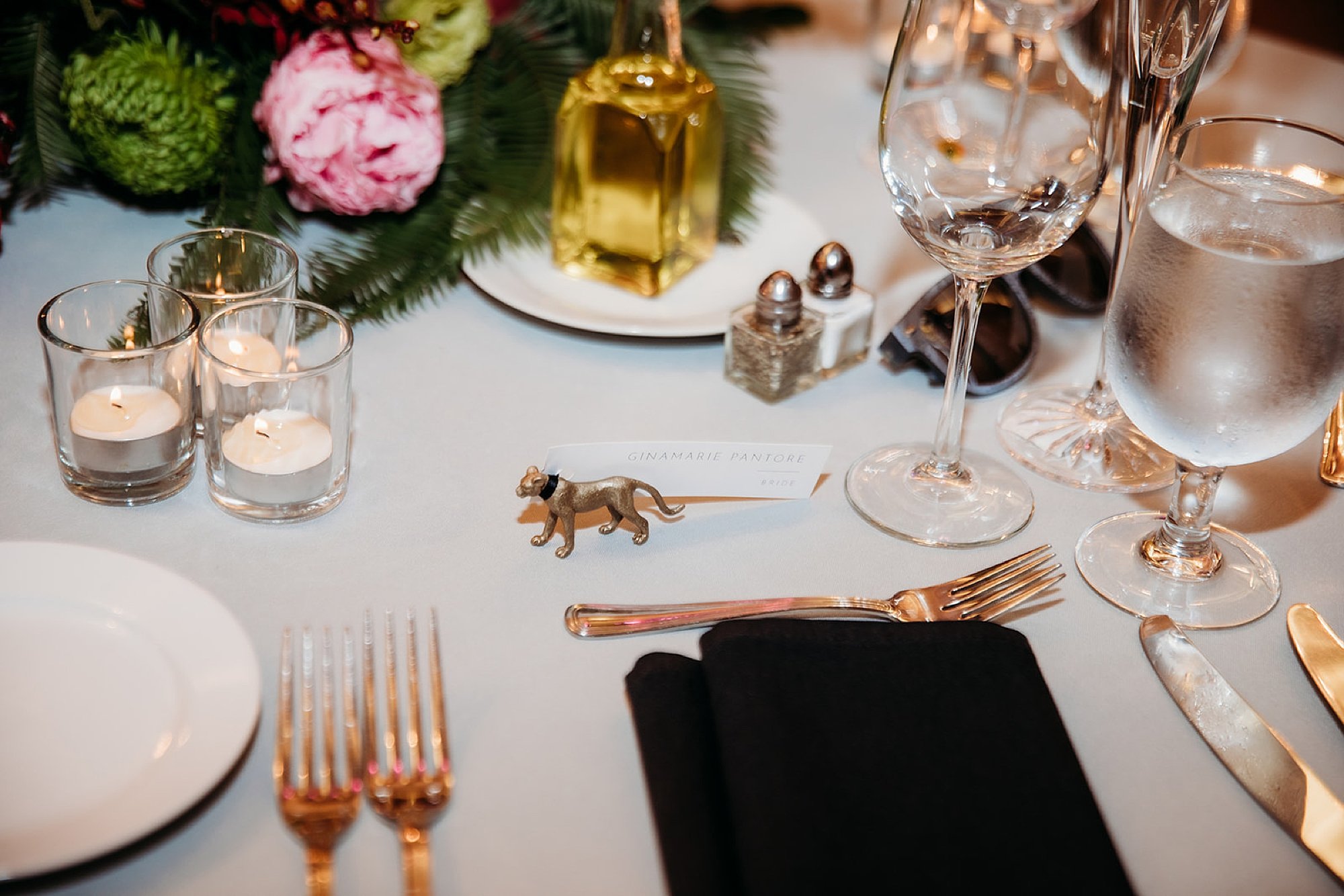 place setting with gold silverware for The Bronx Zoo wedding reception at the Old Lion House