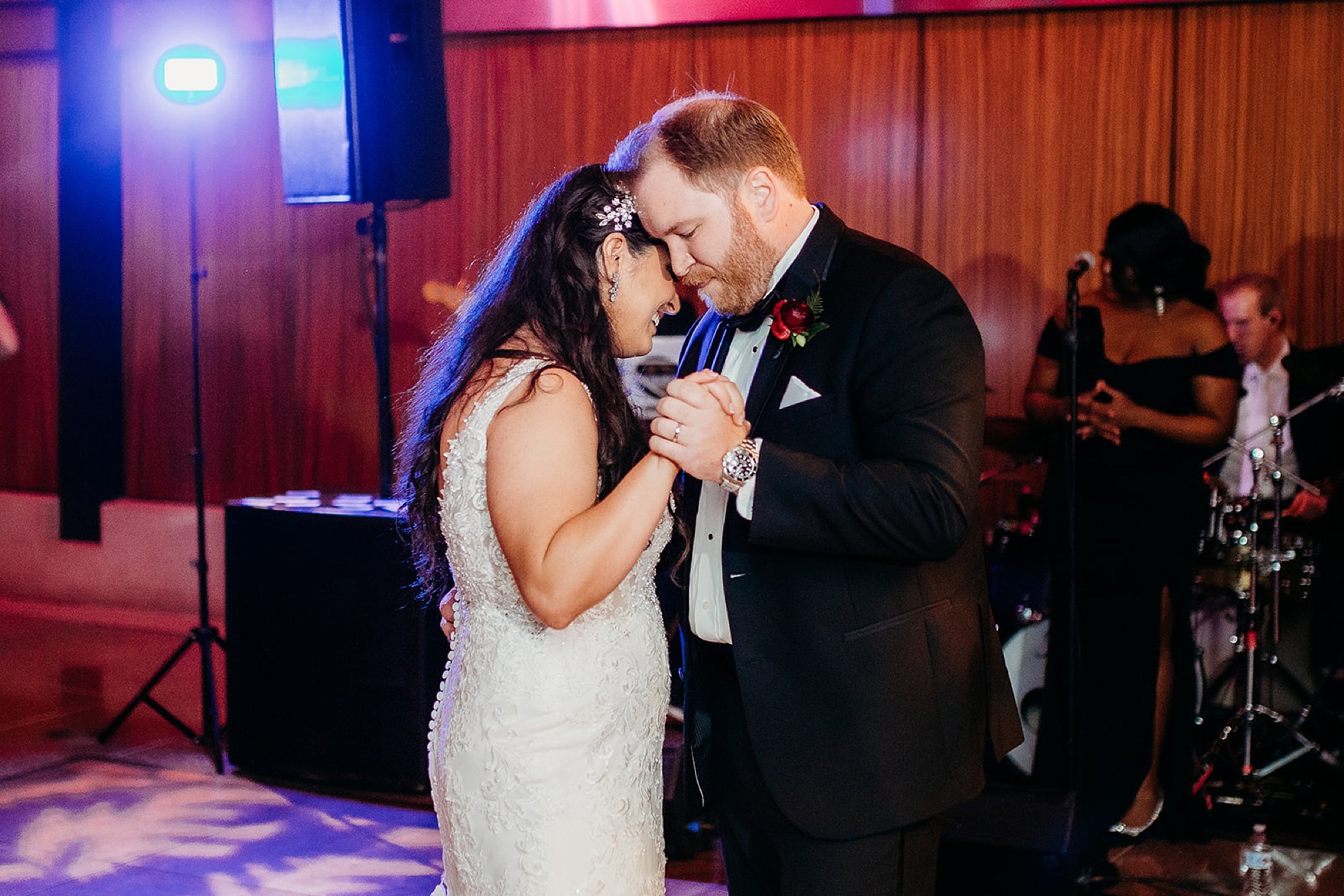 groom hugs bride to him during first dance 