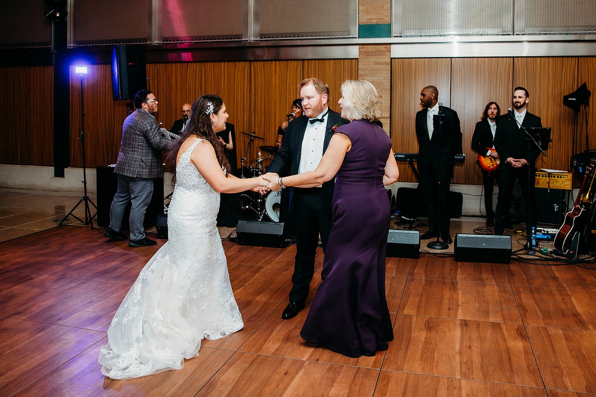 groom, bride, and mother dance during the Bronx Zoo reception
