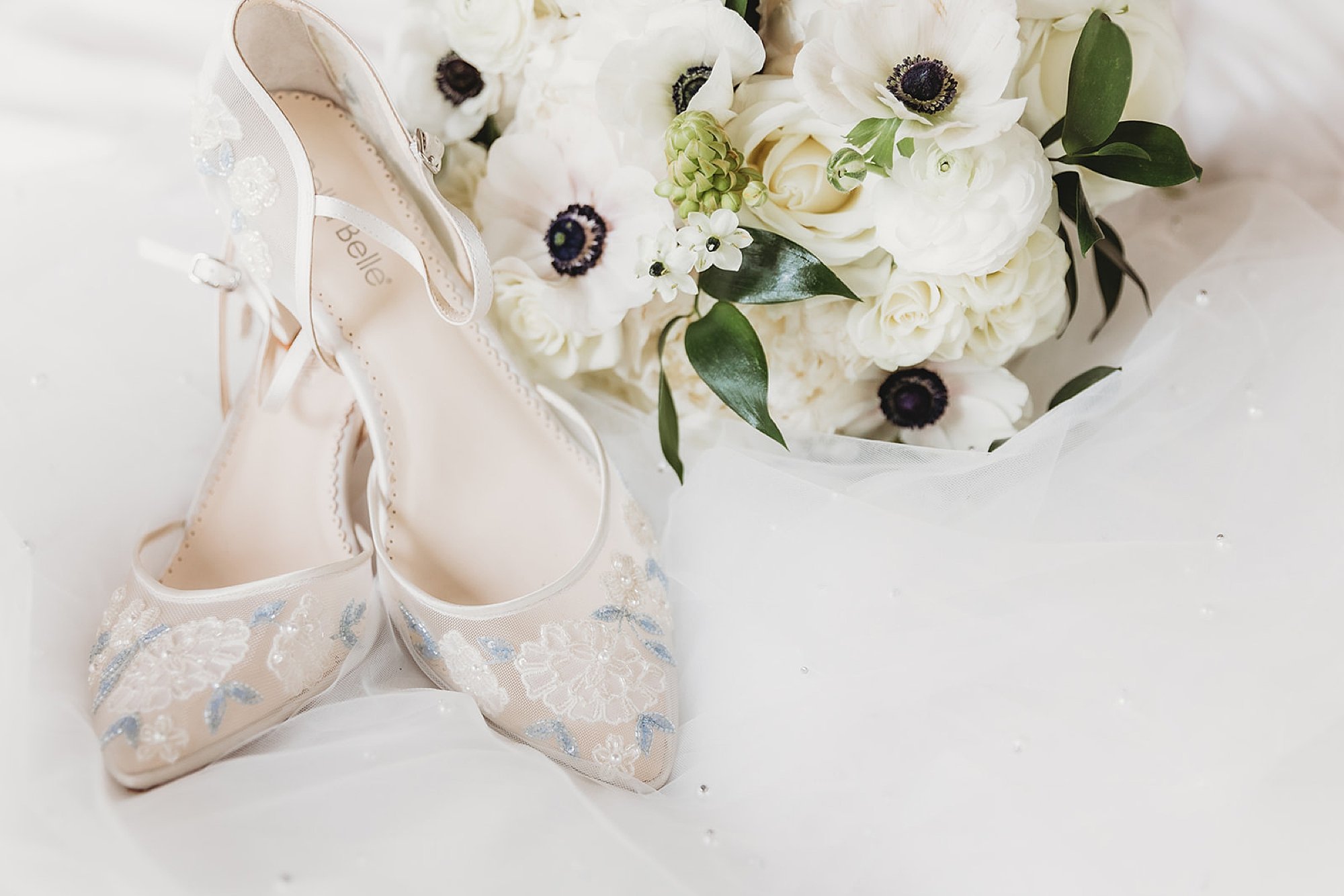 ivory shoes with jeweled details by white bouquet 
