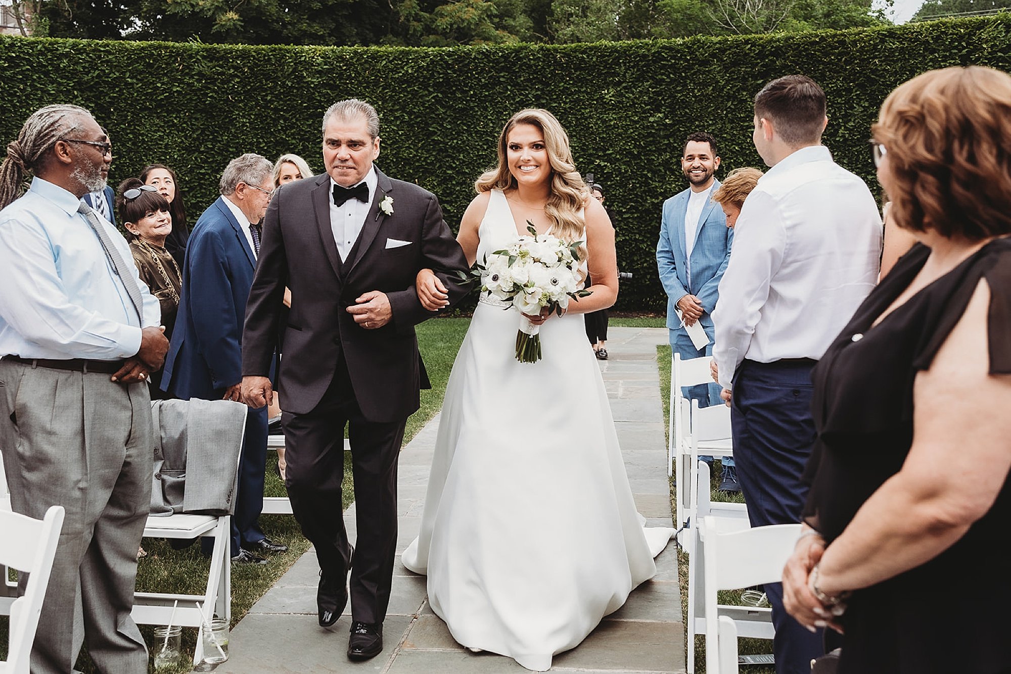 bride and father enter wedding ceremony in gardens at The Roadhouse in Beacon NY